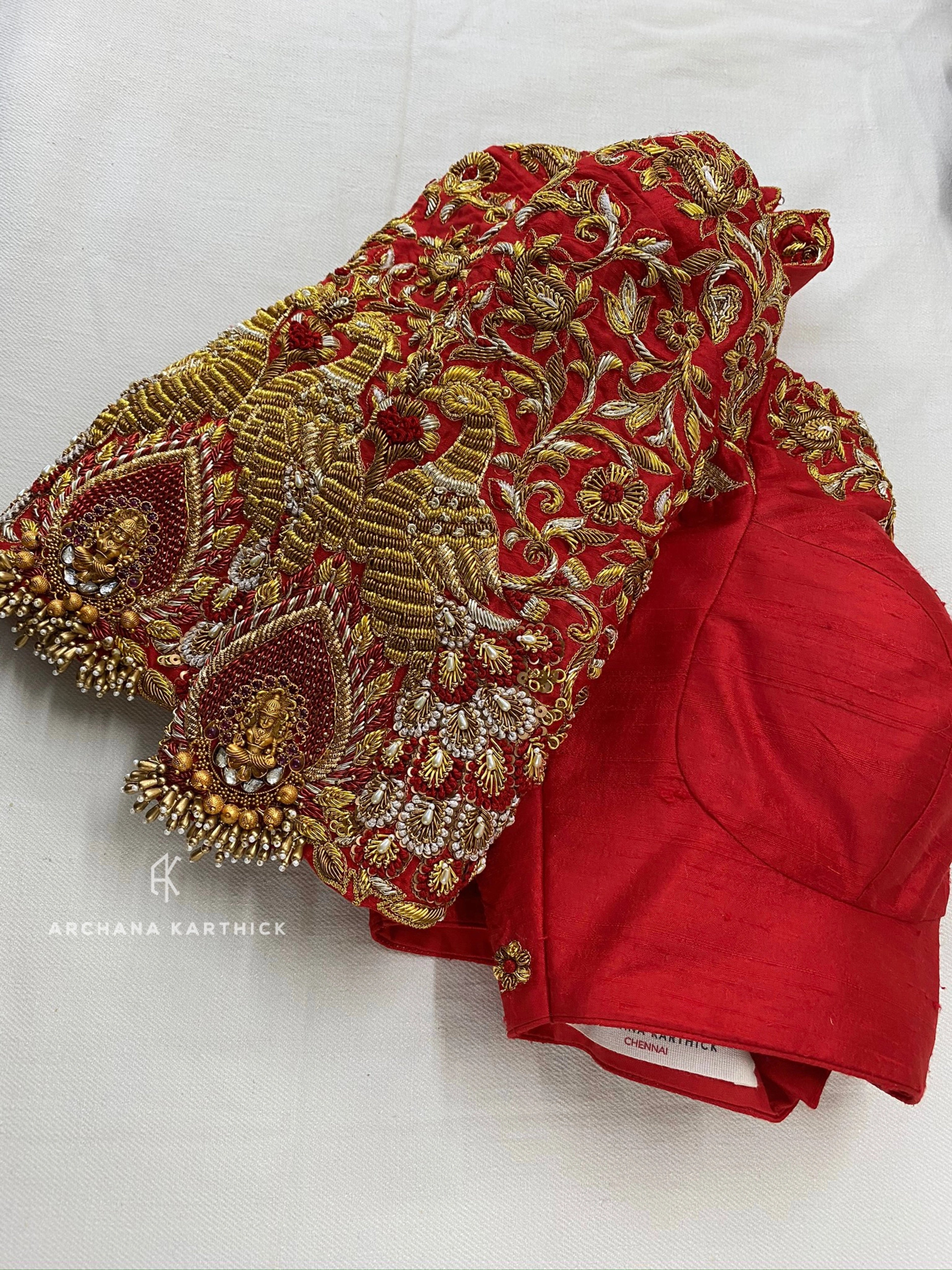 A red silk blouse handcrafted by team Archana Karthick for bride Pooja from Bangalore.