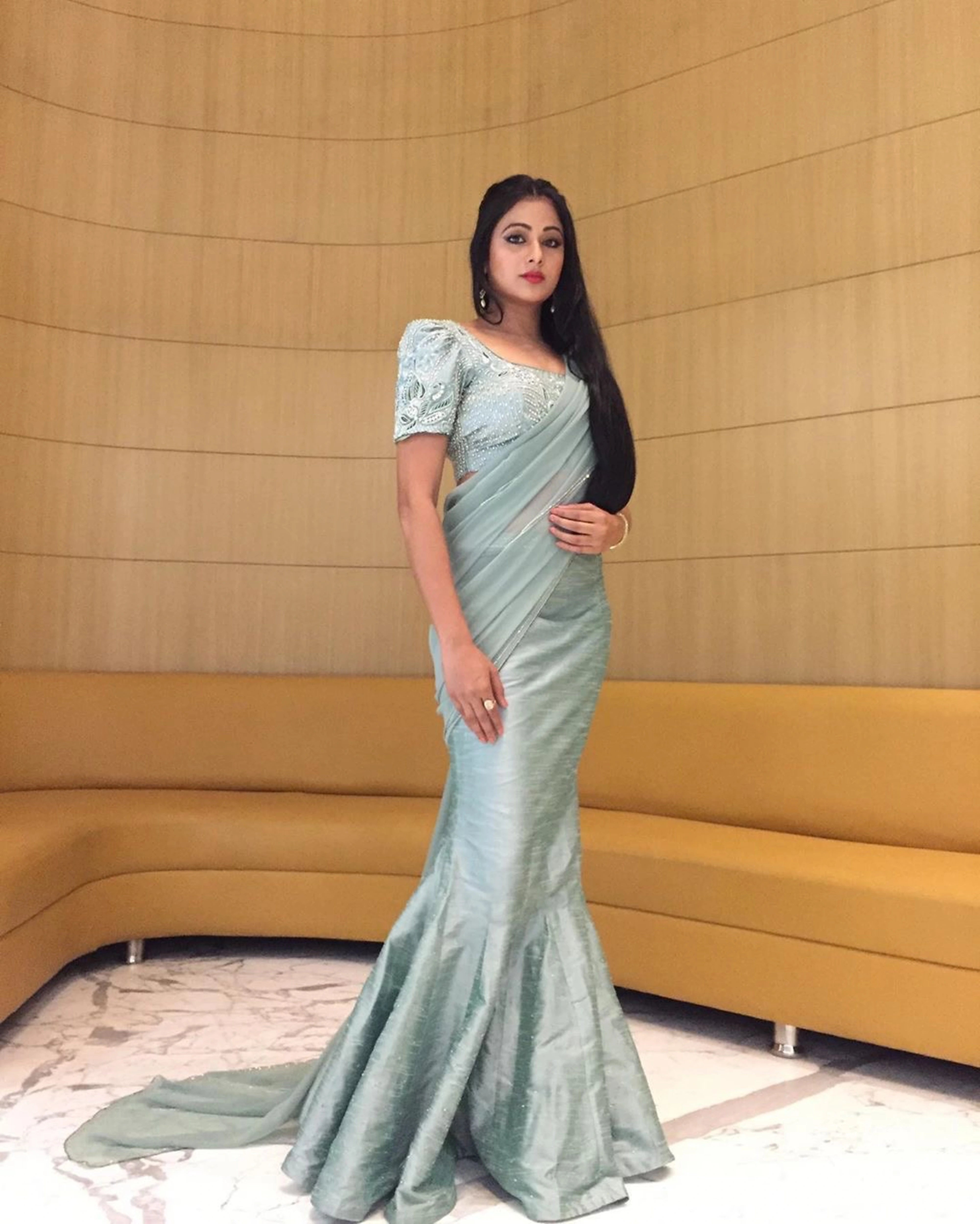 Actress Archita Sahu in a light sea green georgette and raw silk draped mermaid lehenga with puff sleeves handcrafted by Archana Karthick.