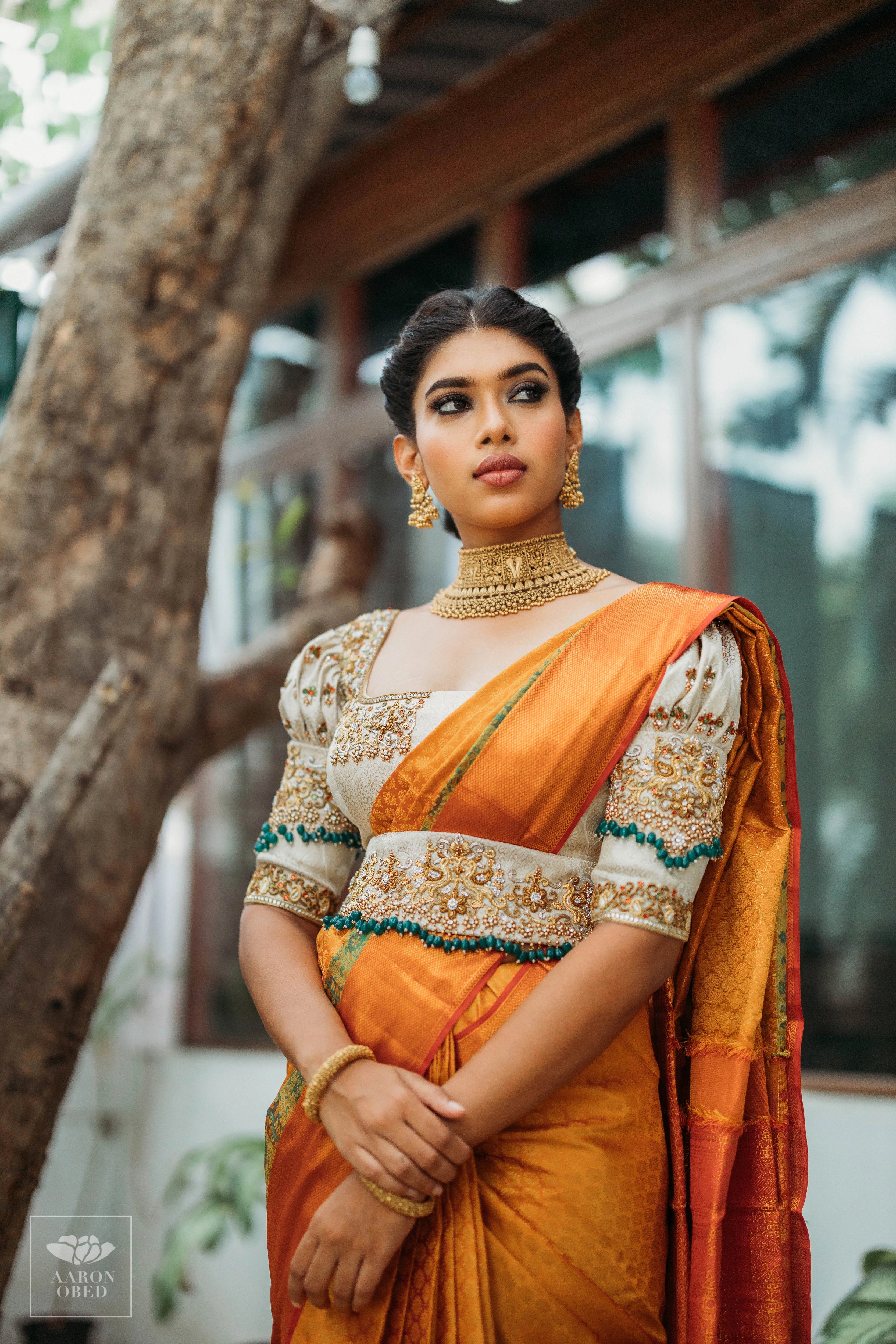 Actress Dushara Vijayan looking far away in a concept ivory brocade blouse and belt, intricately handcrafted with zardozi, beads, crystals, zari and kundan.
