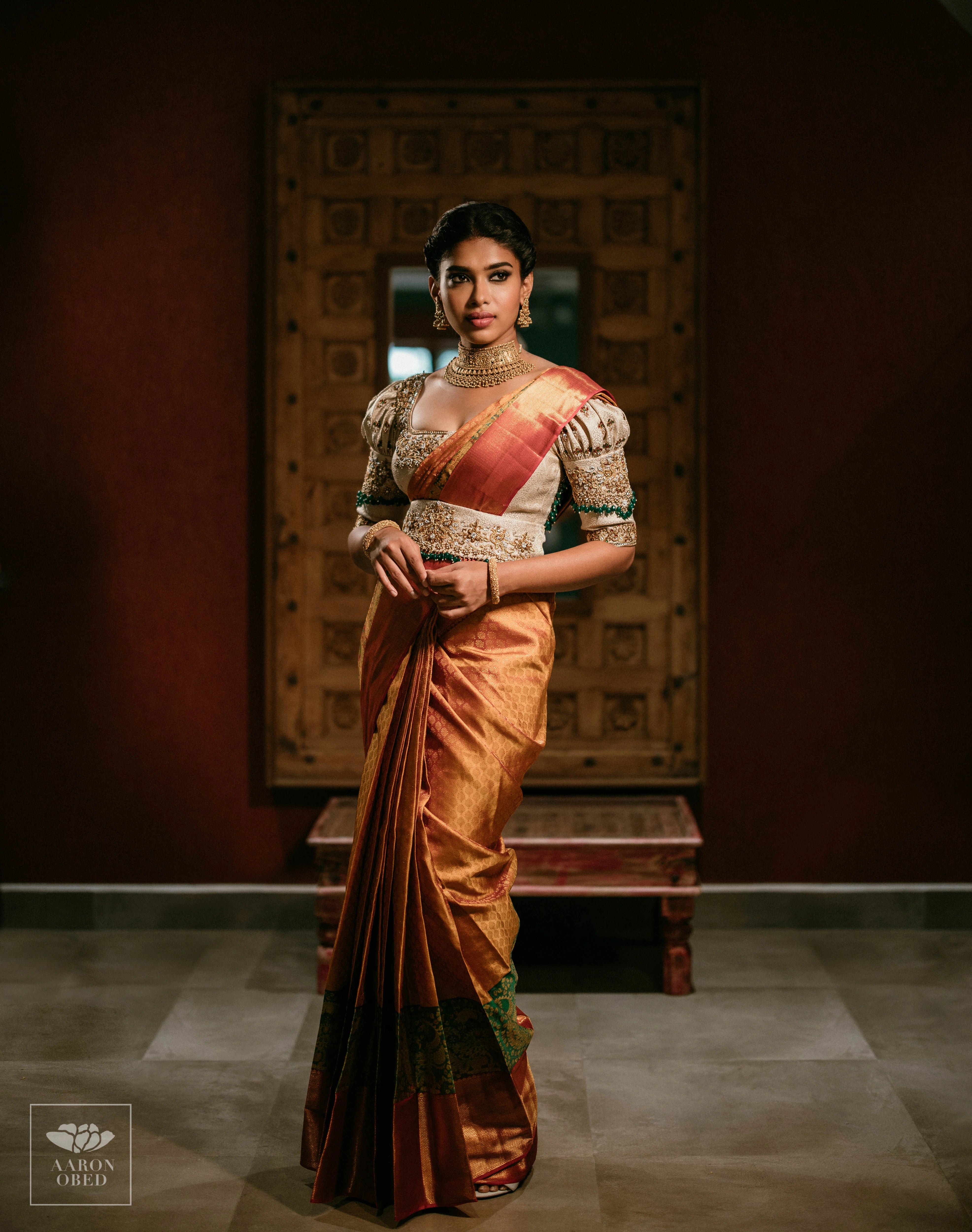 Actress Dushara Vijayan looking left in a concept ivory brocade blouse and belt, intricately handcrafted with zardozi, beads, crystals, zari and kundan.