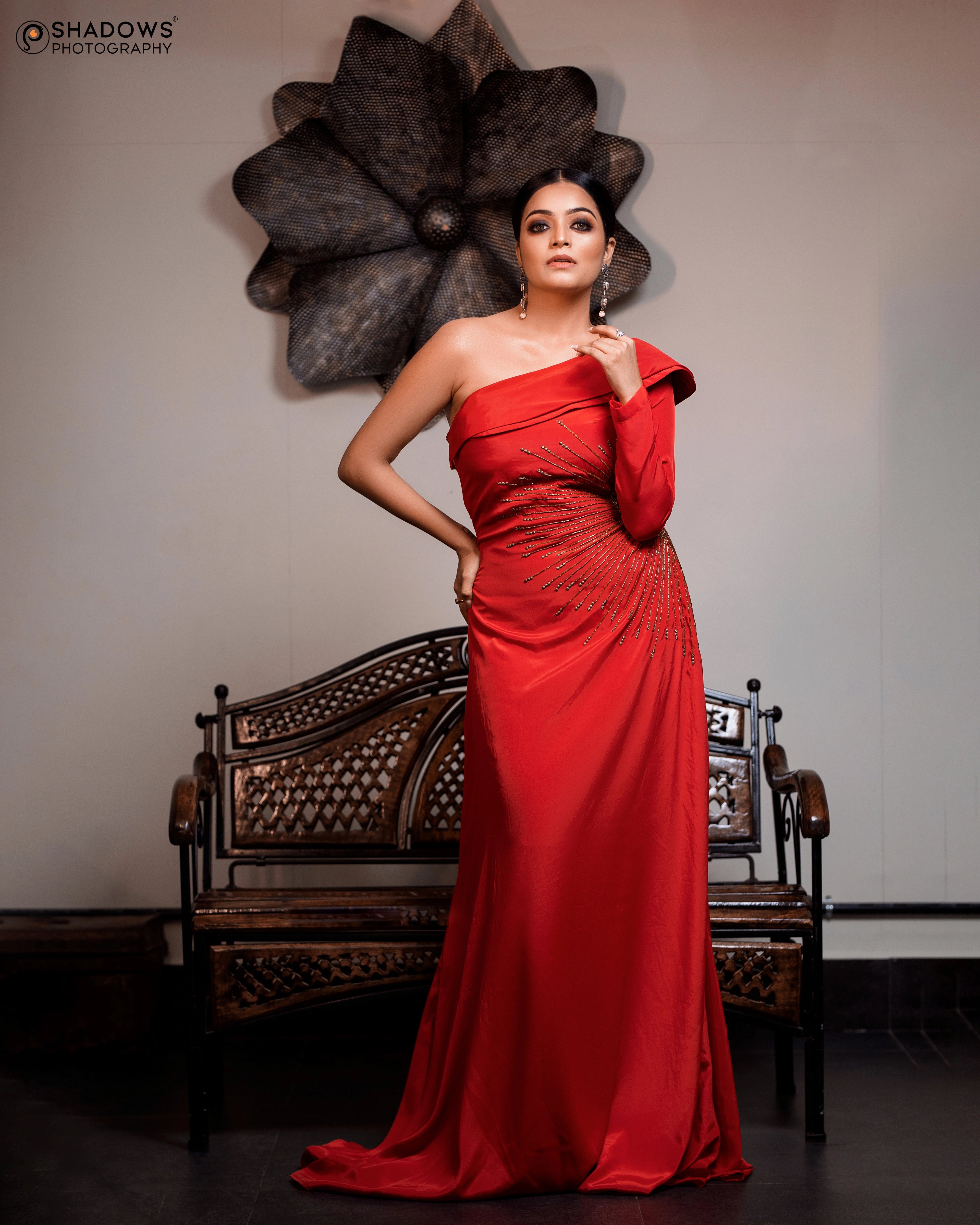 Actress Janai Iyer in a red crepe silk one-shoulder asymmetric gown, intricately handcrafted with sequins, zardozi, cutdana and beads by team Archana Karthick.
