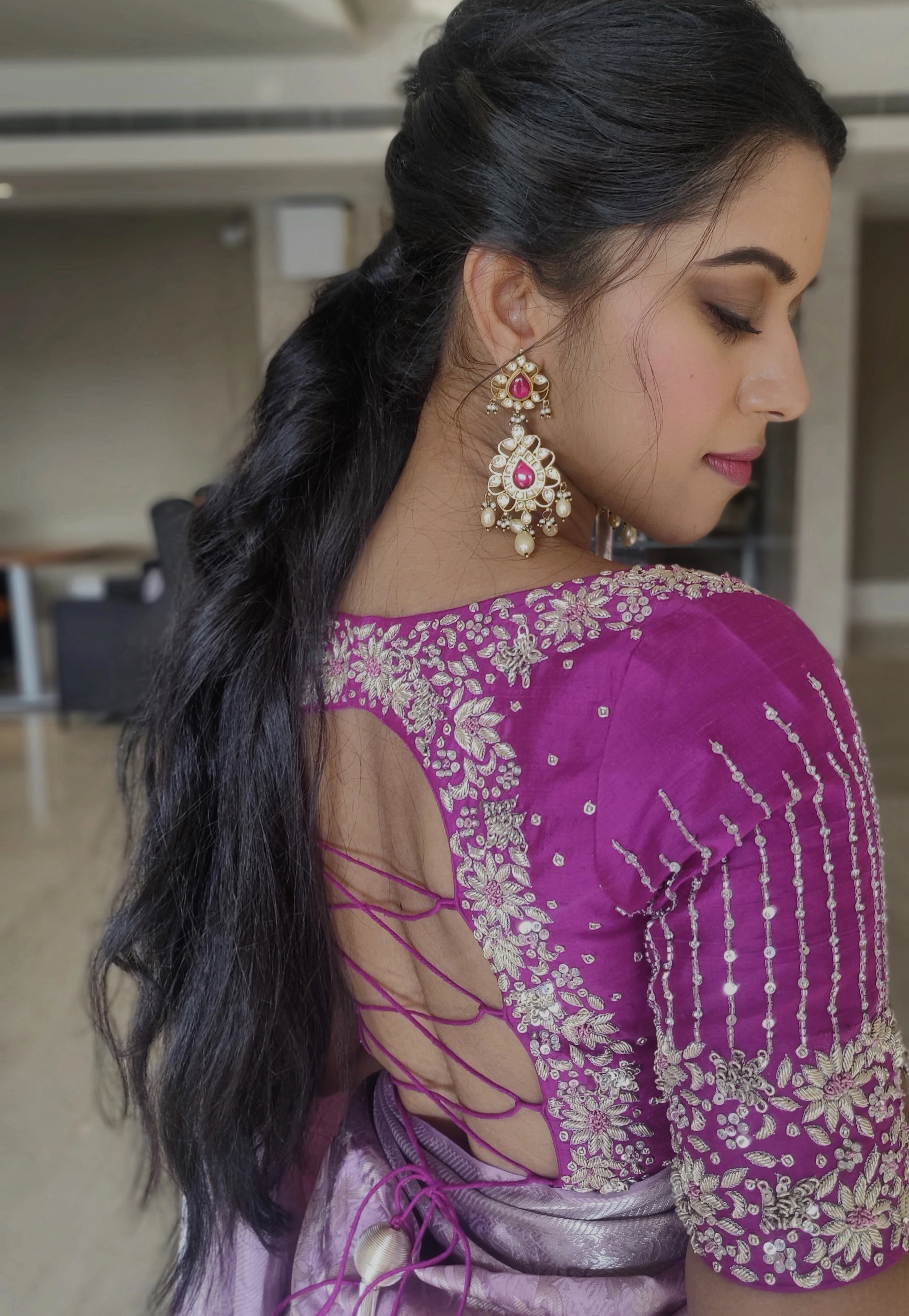 Actress Mirnalini Ravi in a magenta raw silk blouse designed by Archana Karthick handcrafted intricately with zardozi, sequins and stones.