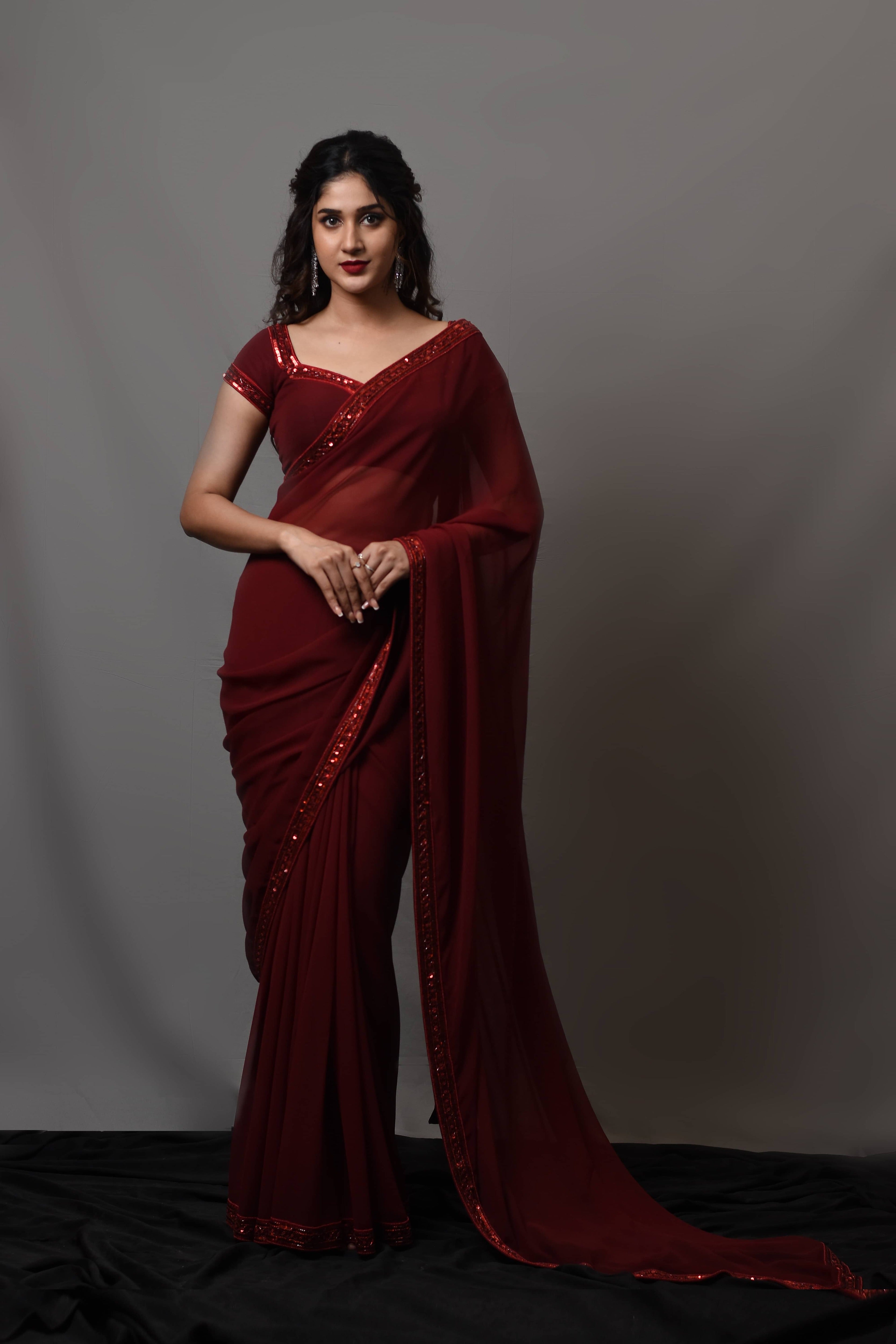 Actress Rabiya Khatoon in a ruby red georgette saree set designed by Archana Karthick.
