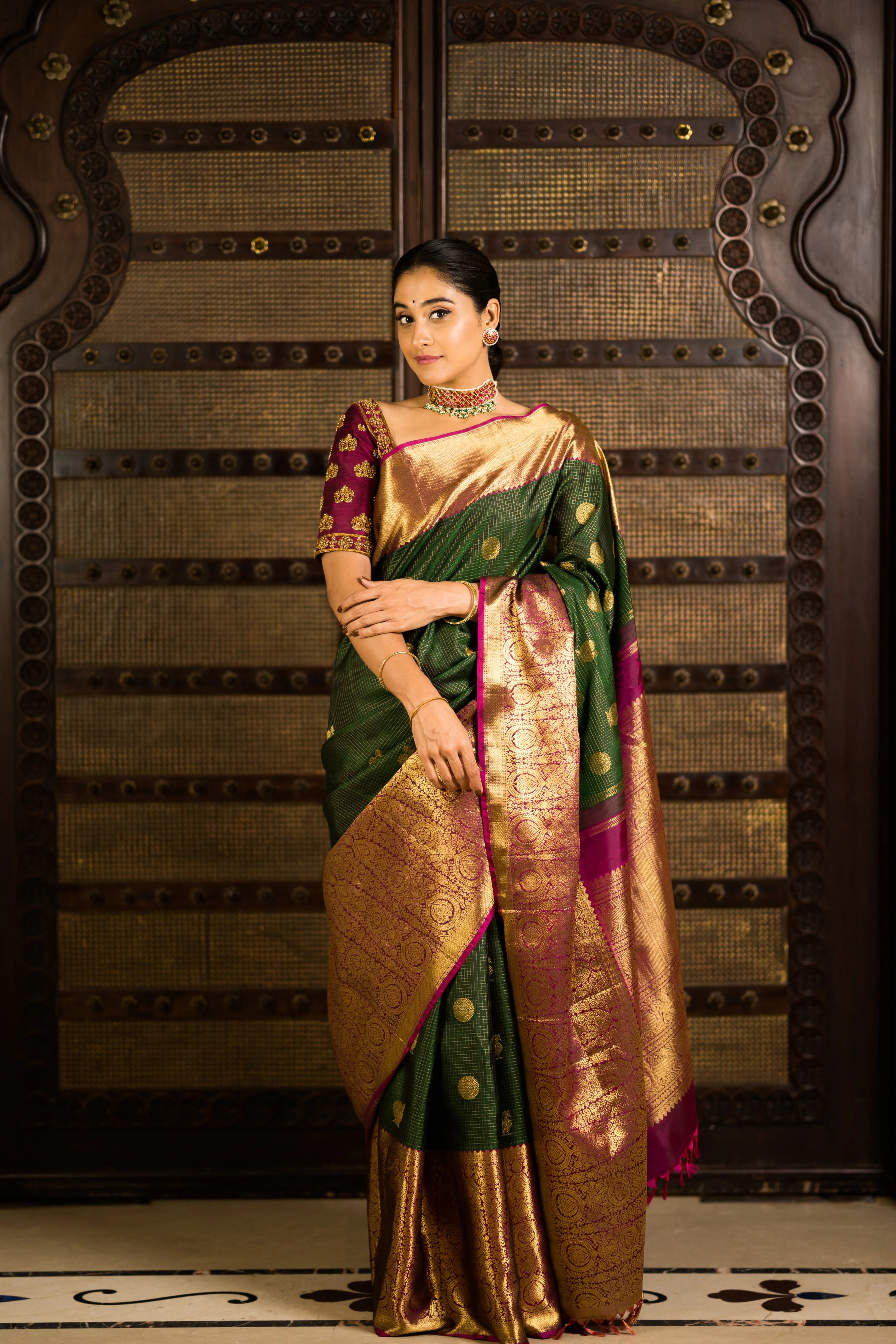 Actress Regina Cassandra posing in a wine red raw silk blouse designed by Archana Karthick. The blouse is handcrafted with zardozi work.