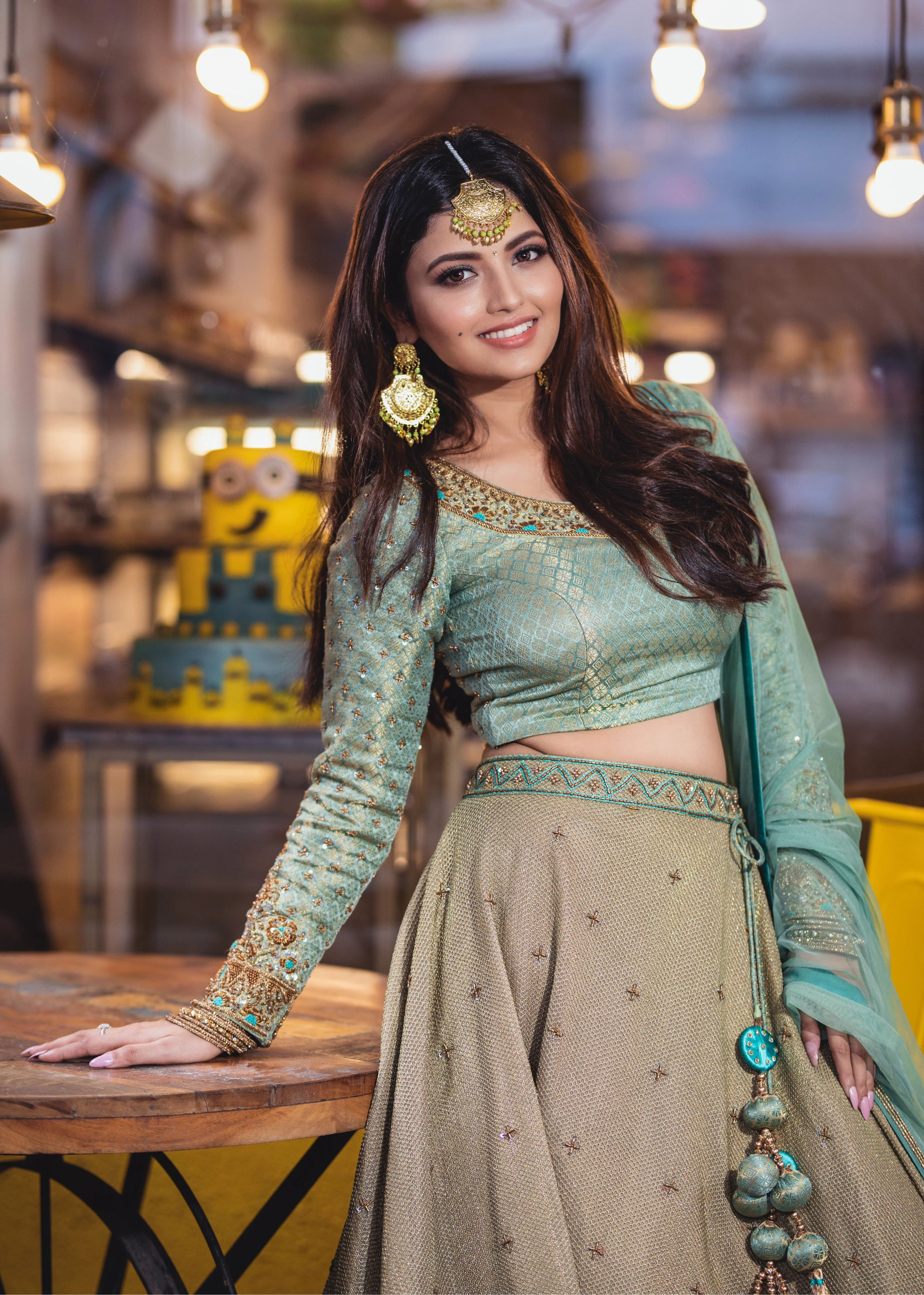 Actress Shirin Kanchwala in a handcrafted banaras (brocade) lehenga in shades of light sea green / pista blue / cyan designed by Archana Karthick posing for front profile