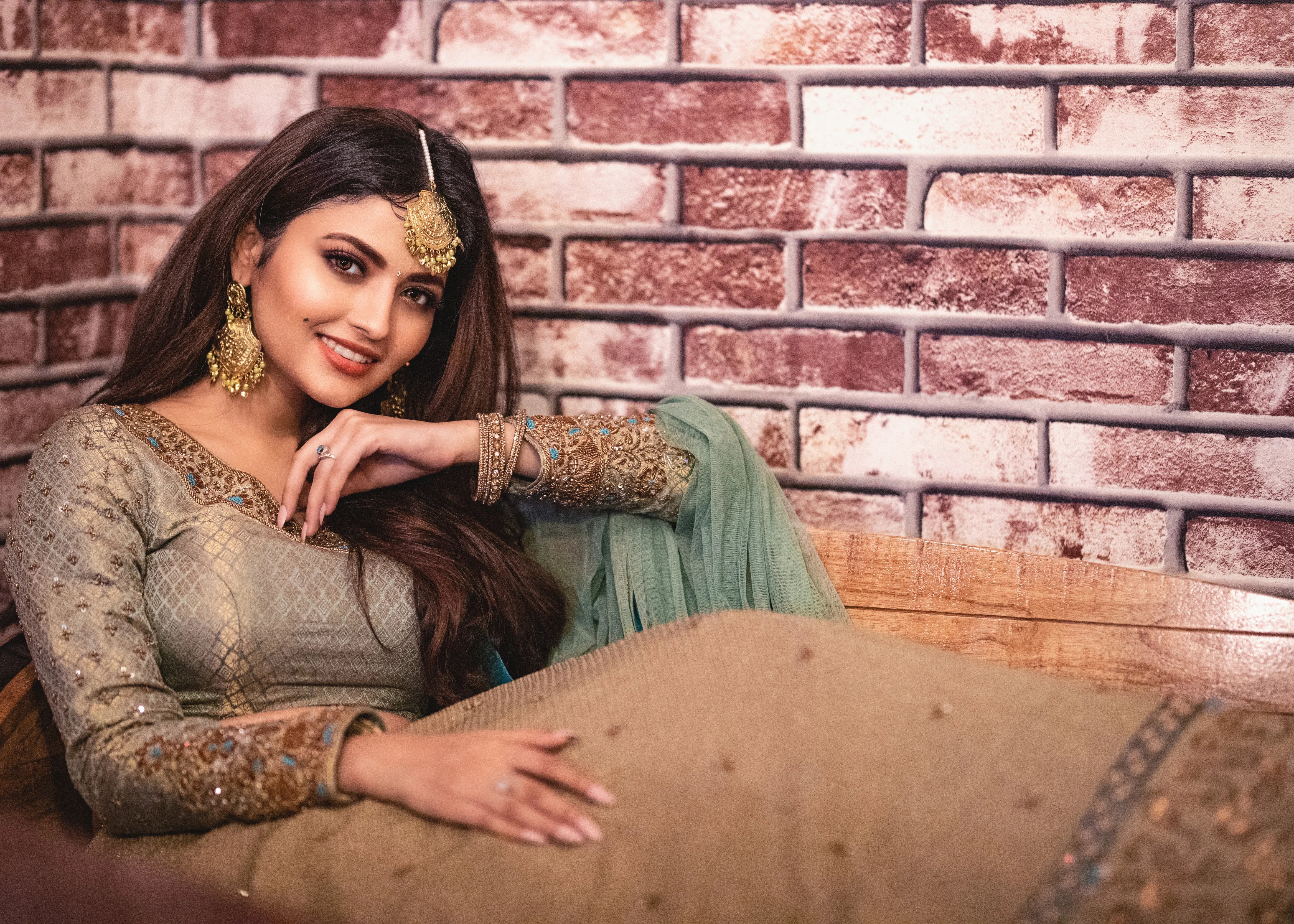 Actress Shirin Kanchwala smiling in a handcrafted banaras (brocade) lehenga in shades of light sea green / pista blue / cyan designed by Archana Karthick