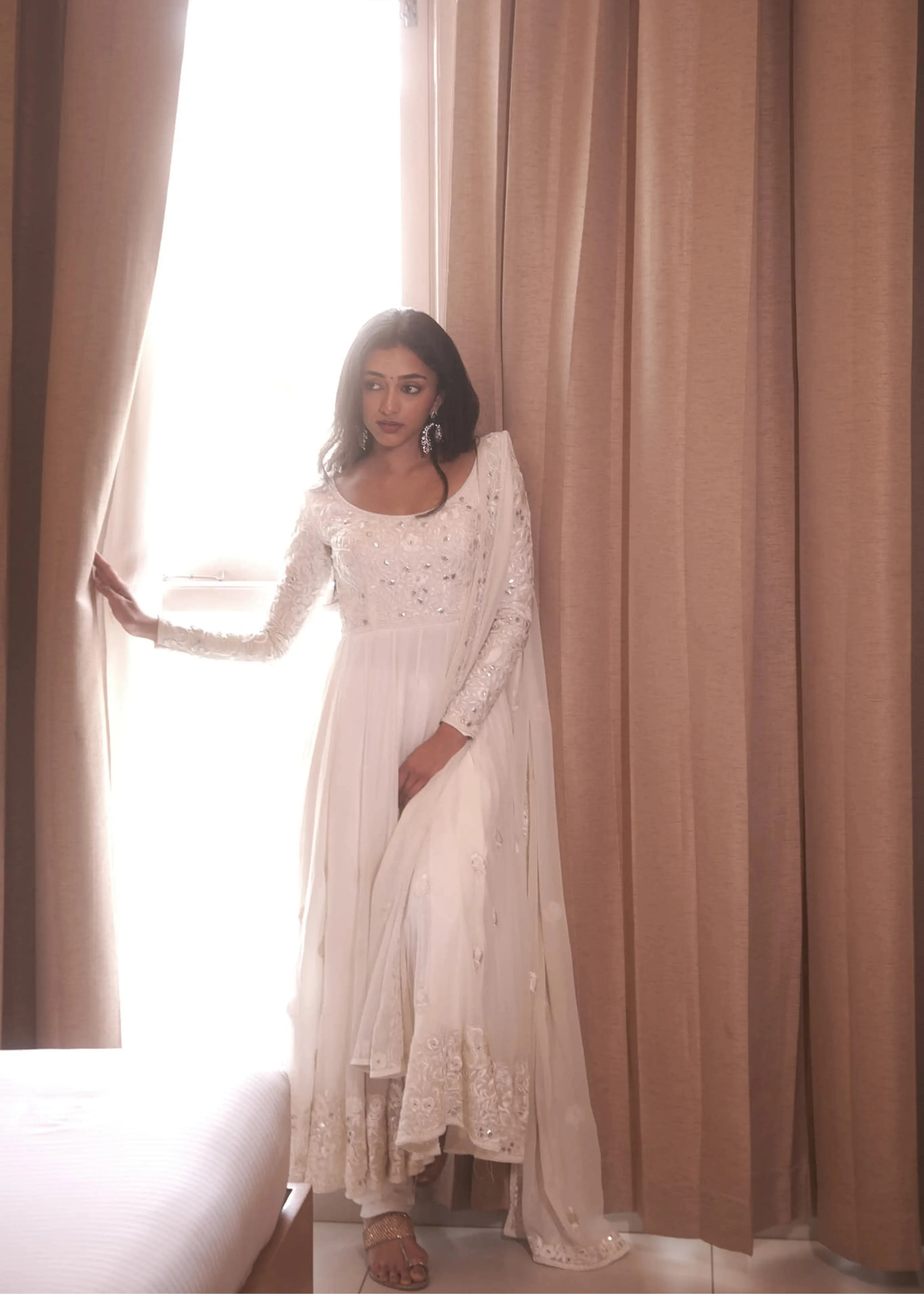Actress & dancer Preity Mukhundhan in a white georgette anarkali intricately handcrafted with gotapati, resham (chikanakri work) by team Archana Karthick.
