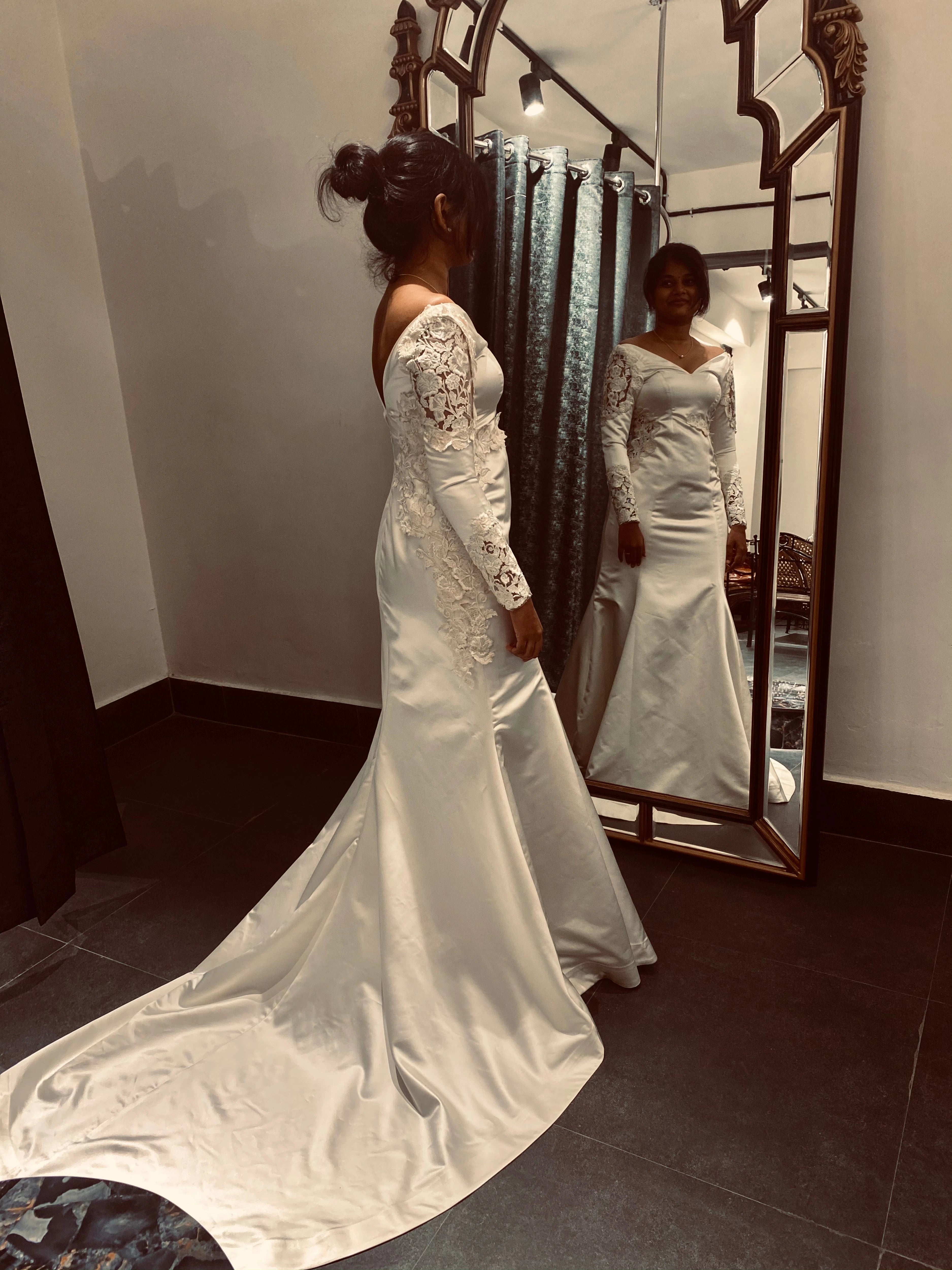 Adeal Josh during her fittings in a white gown for her church wedding, handcrafted by team Archana Karthick.