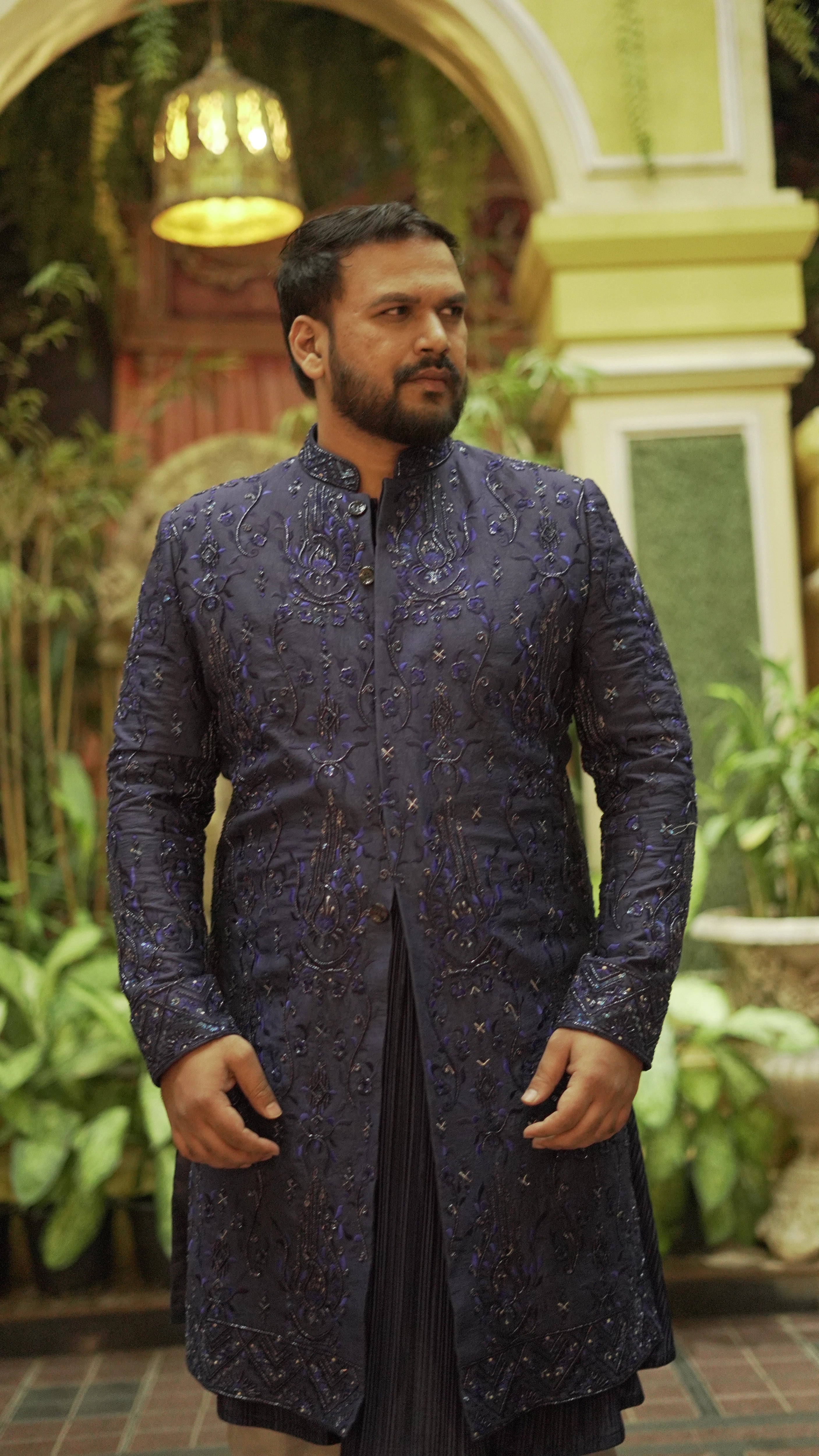 Amiya from Odisha posing in a blue lehenga and sherwani handcrafted by team Archana Karthick