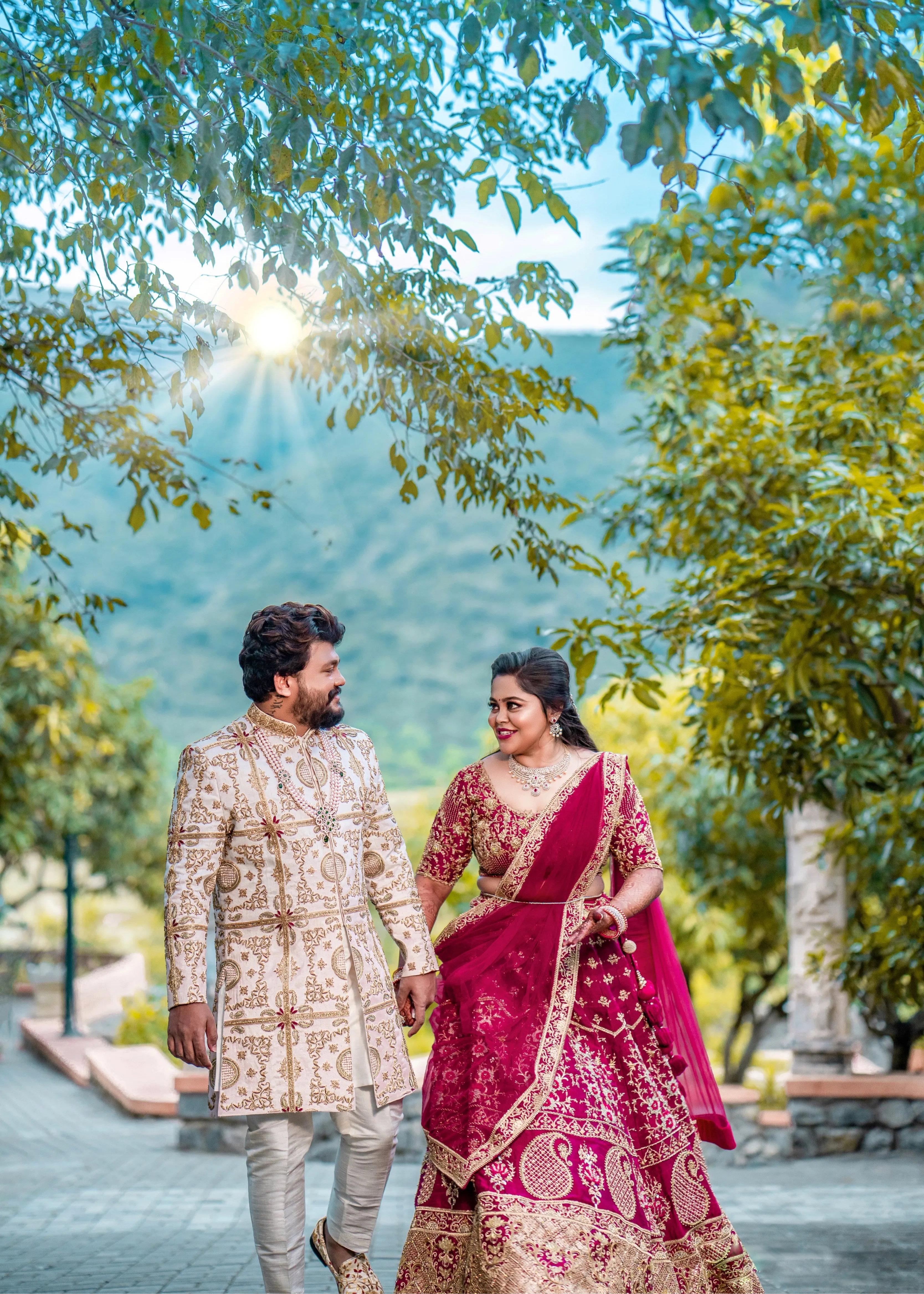 Anjana (Coimbatore) and Sandeep (Chennai) in custom Archana Karthick for their wedding. Bridal lehenga is a magenta red raw silk with zardozi and resham knot work embellishments. Grrom's sherwani has similar work on ivory raw silk.