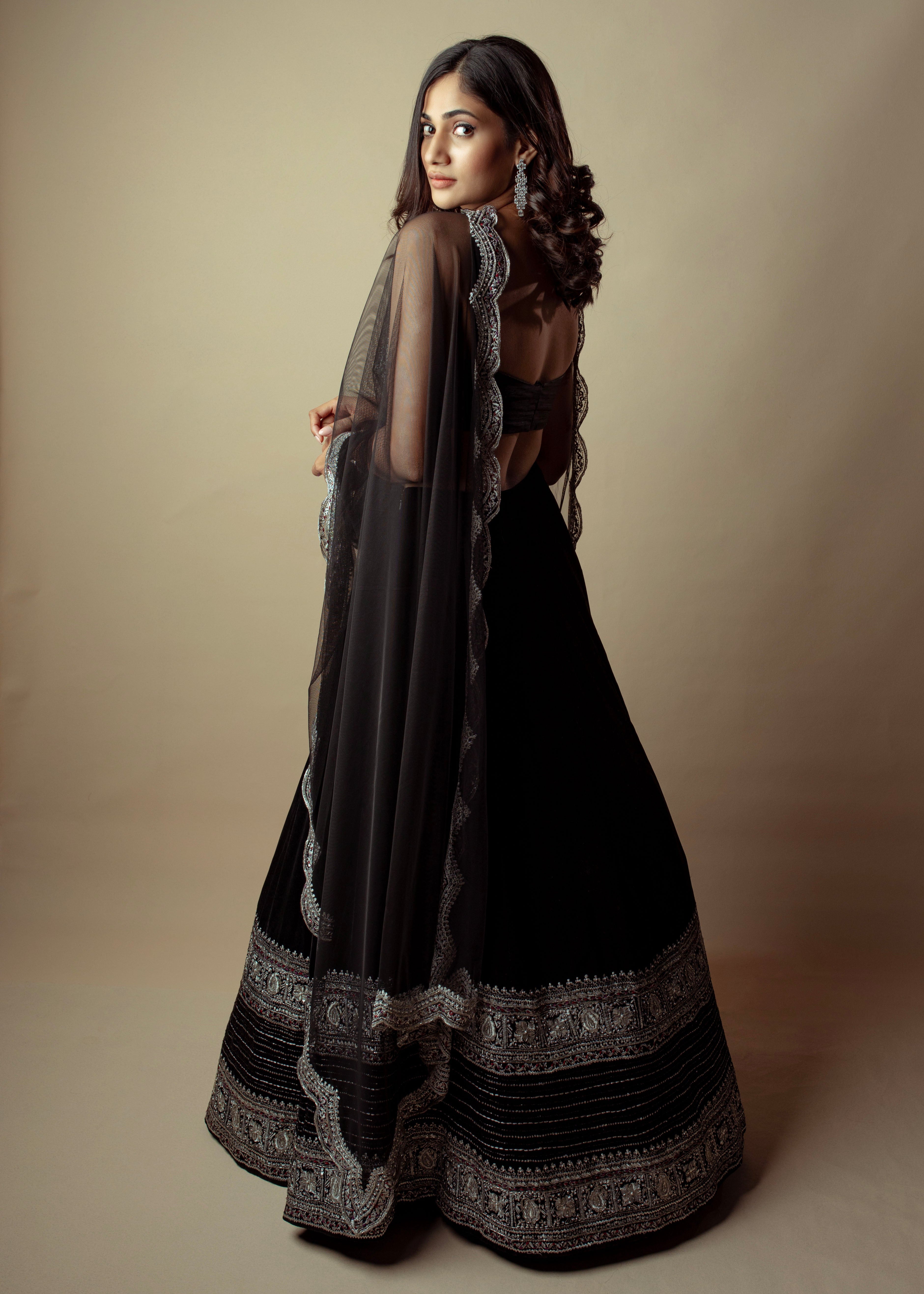 Bigg Boss fame and actress Losliya Mariyanesan in black velvet lehenga with a silver embellishments on the borders and bralette.