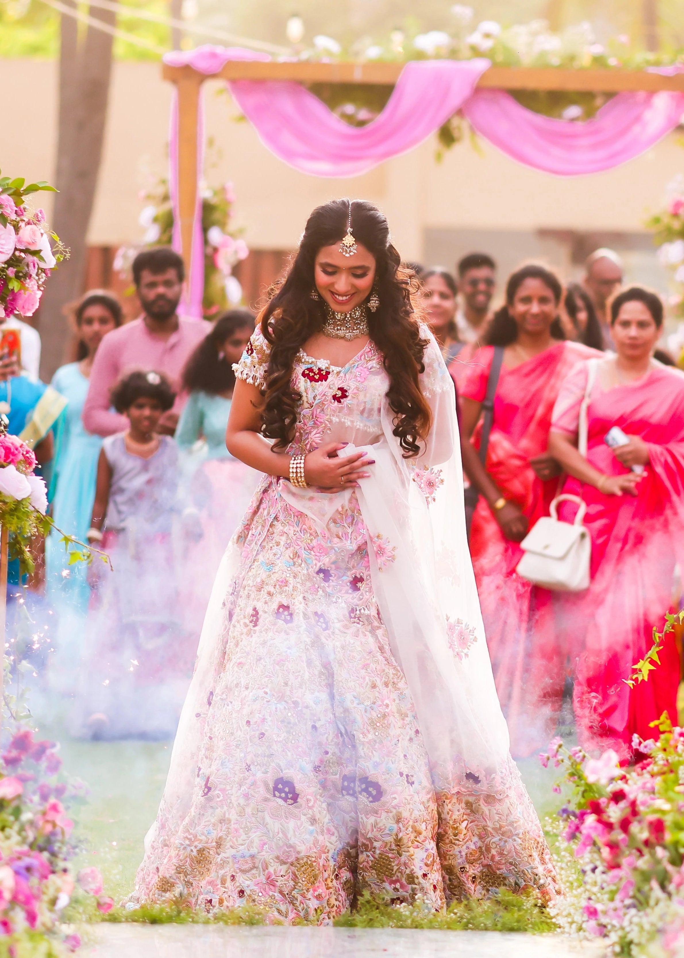 Bride Aarthi Rajagopal from USA smiling again in a concept ivory lehenga, intricately handcrafted with resham knot work, crystals, cutdana, pearls, sequins and zardozi.