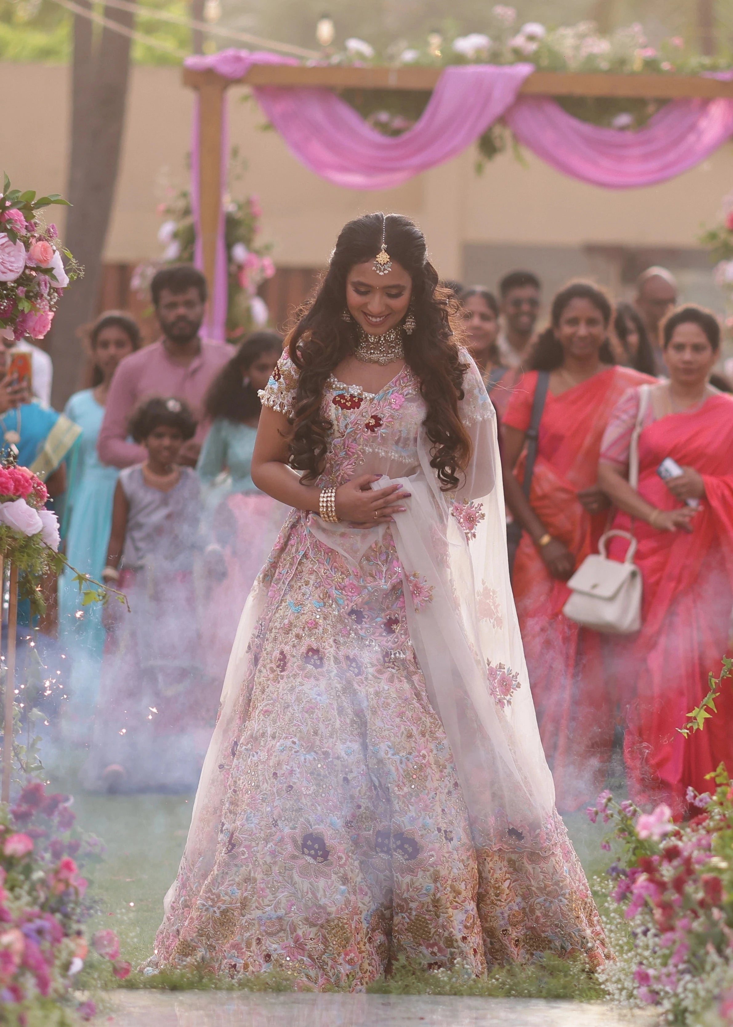 Bride Aarthi Rajagopal from USA smiling in a concept ivory lehenga, intricately handcrafted with resham knot work, crystals, cutdana, pearls, sequins and zardozi.