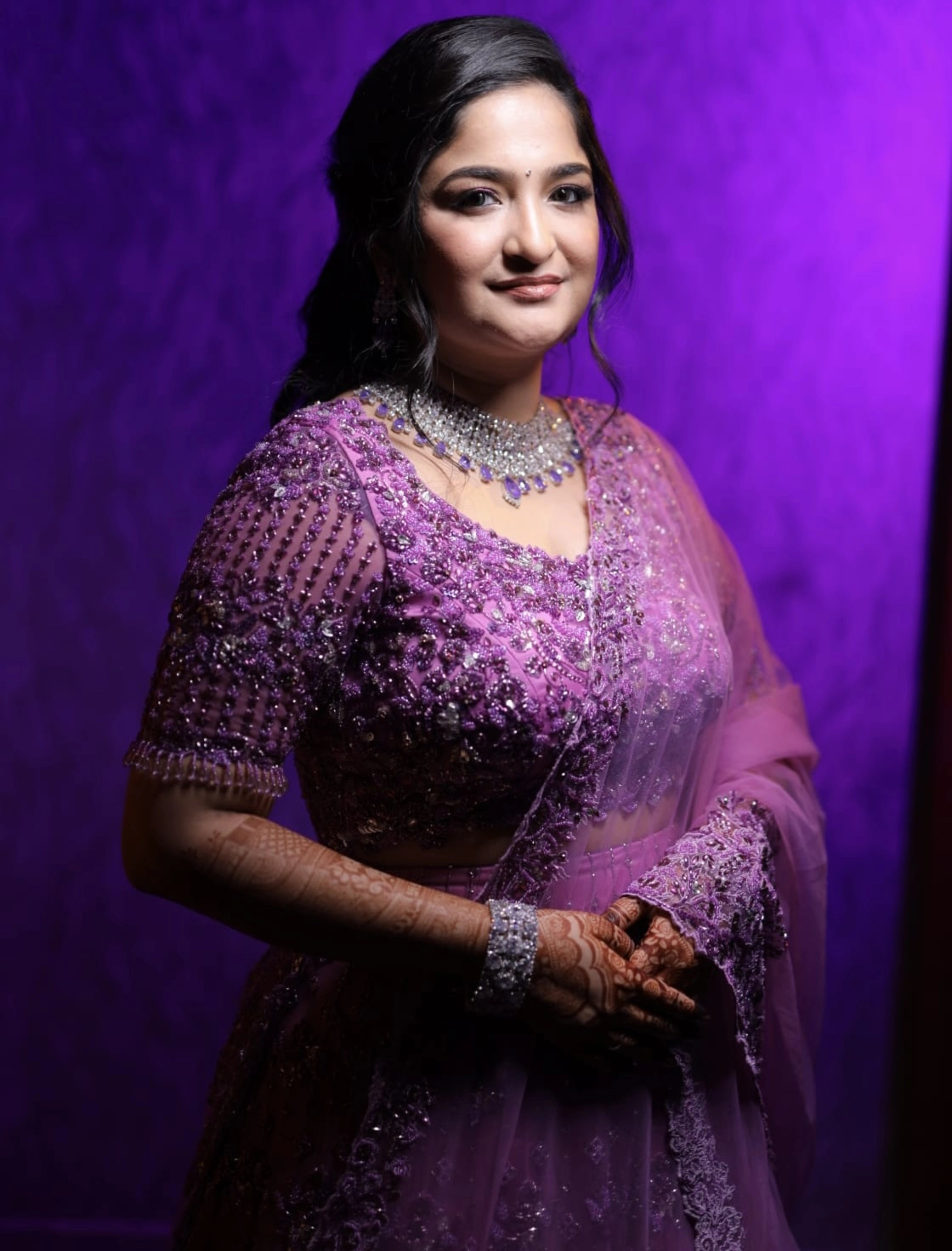 Bride Aarthi from USA posing in a lavender lehenga by Archana Karthick