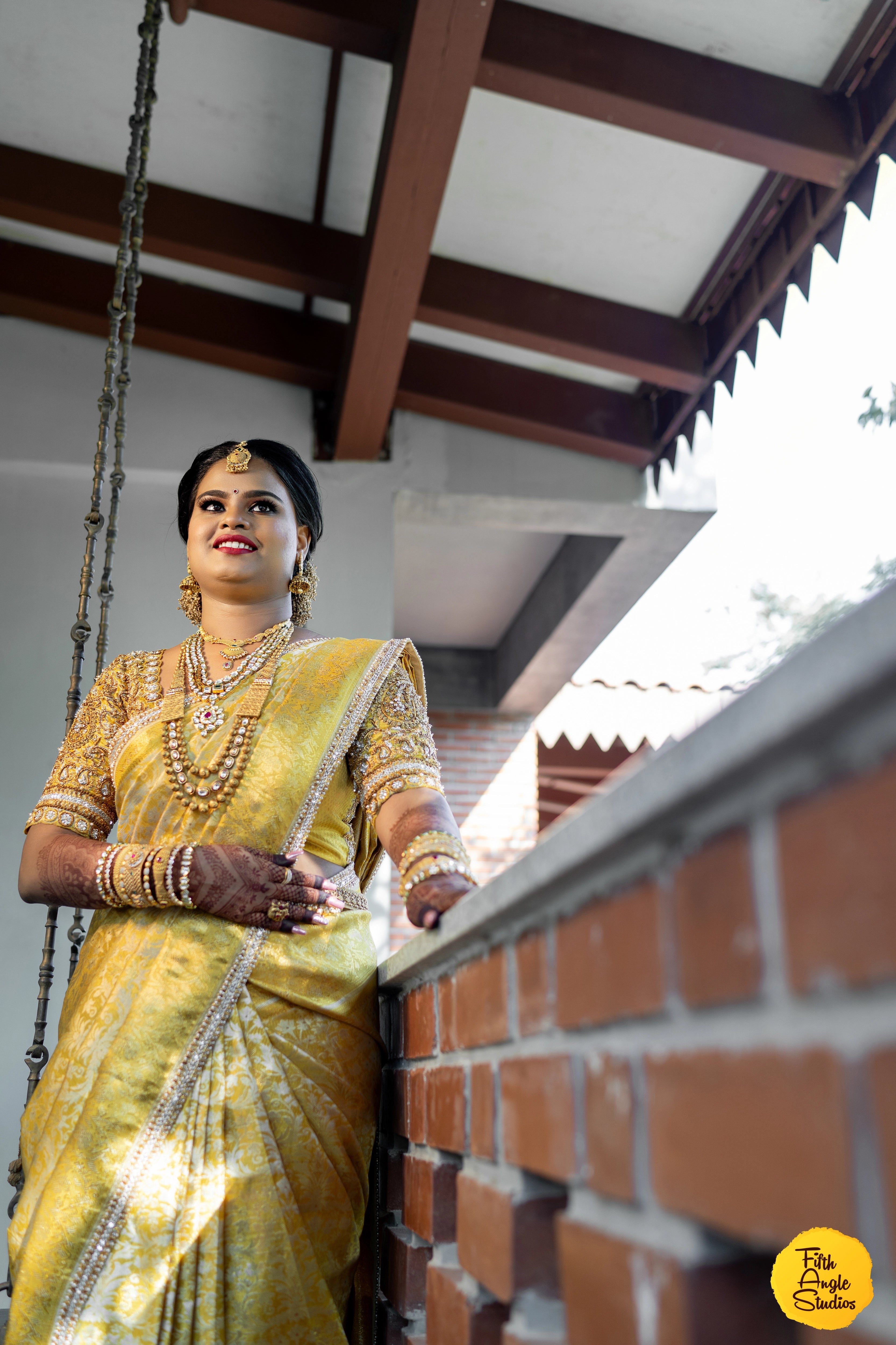 Bride Abinaya V in a gold concept silk blouse and saree border, intricately handcrafted by team Archana Karthick.