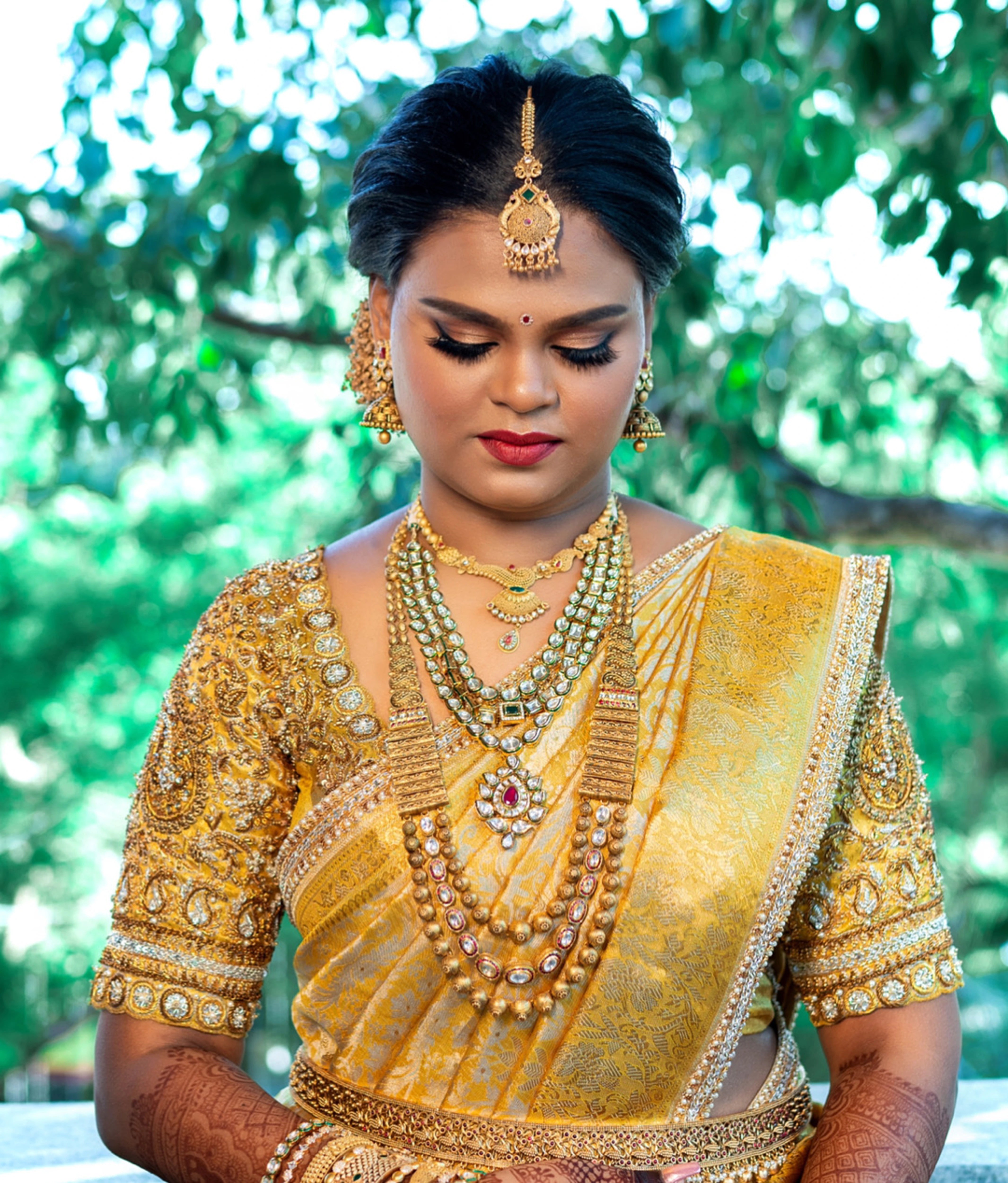 Bride Abinaya V in a gold concept silk blouse and saree border, intricately handcrafted with zardosi, beads, stone, zari and pearls by team Archana Karthick.