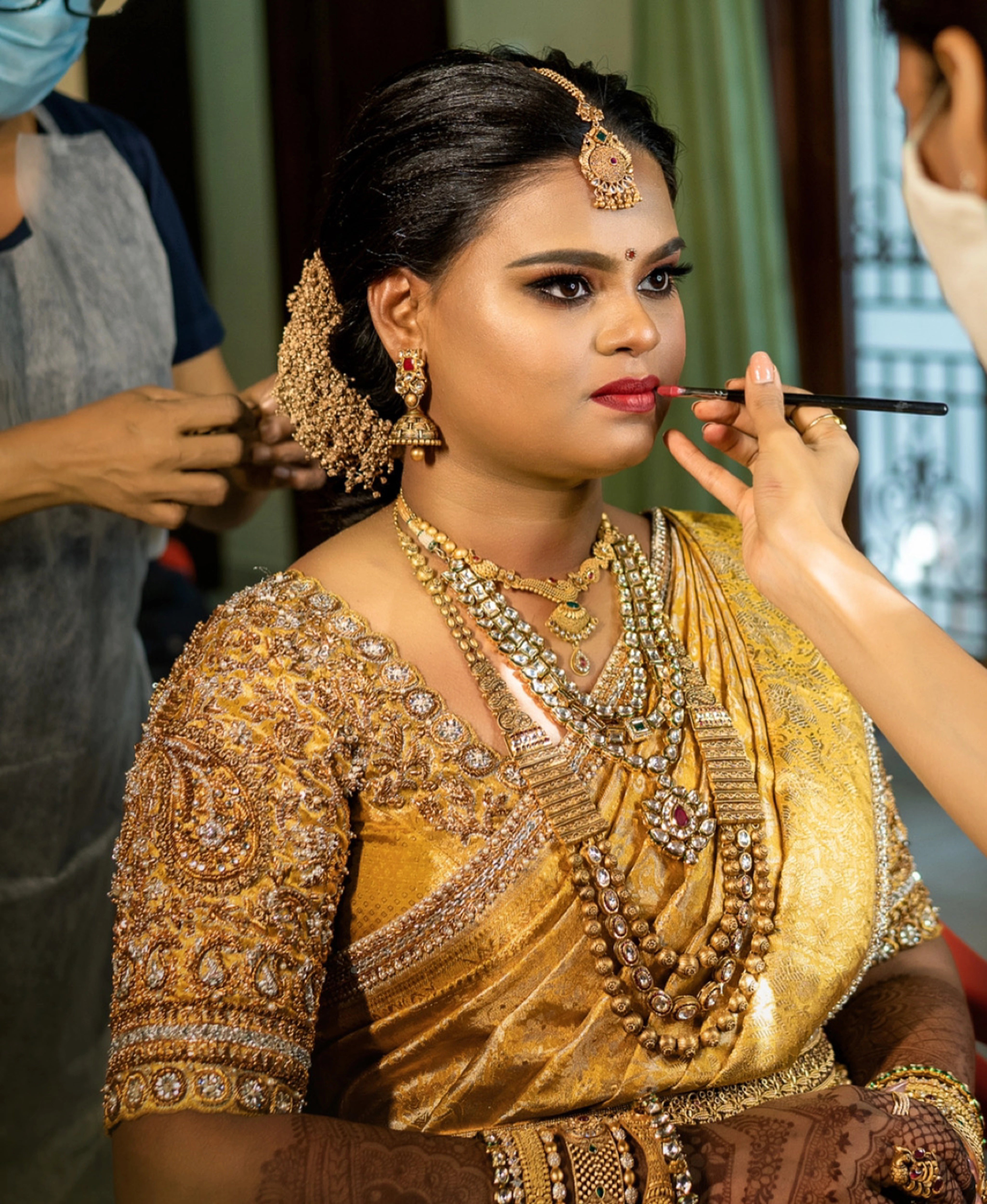 Bride Abinaya V posing in a gold concept silk blouse and saree border, intricately handcrafted with zardosi, beads, stone, zari and pearls by team Archana Karthick.