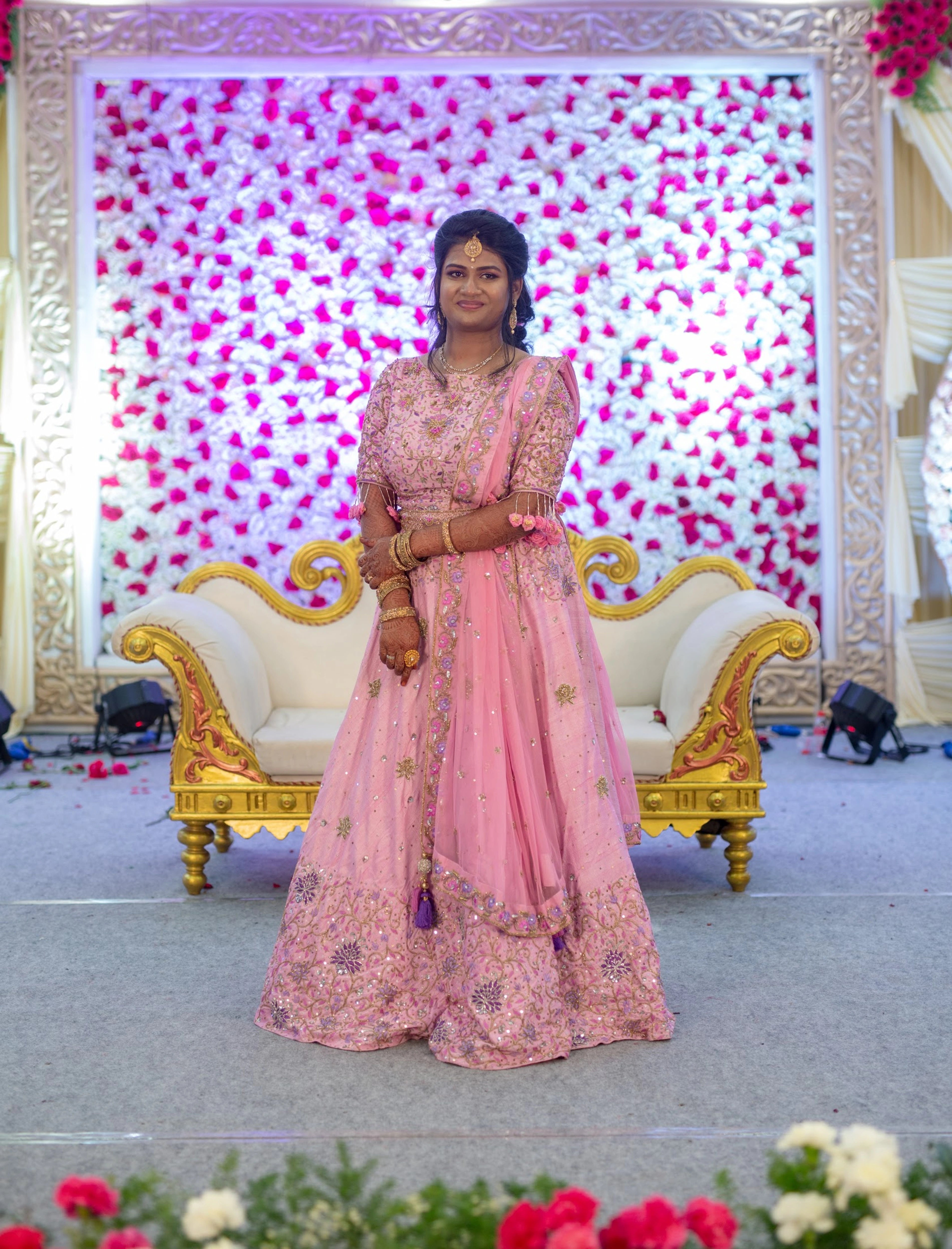 Bride Aishwarya in a pink raw silk lehenga with belt, intricately handcrafted with sequins, cutdana, beads, resham and stones by team Archana Karthick.