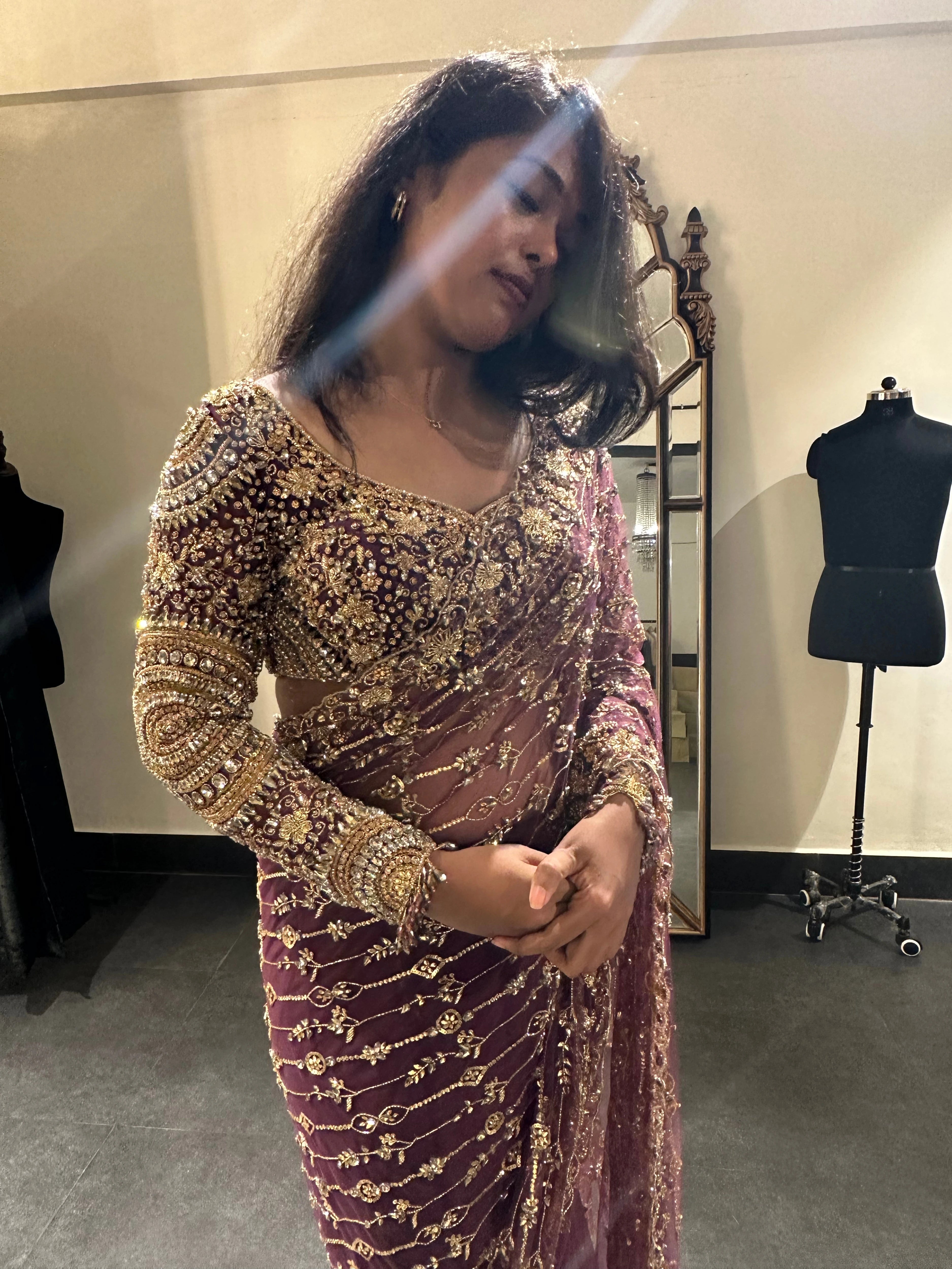 Bride Akalya during fittings in a wine red tulle saree handcrafted by team Archana Karthick.