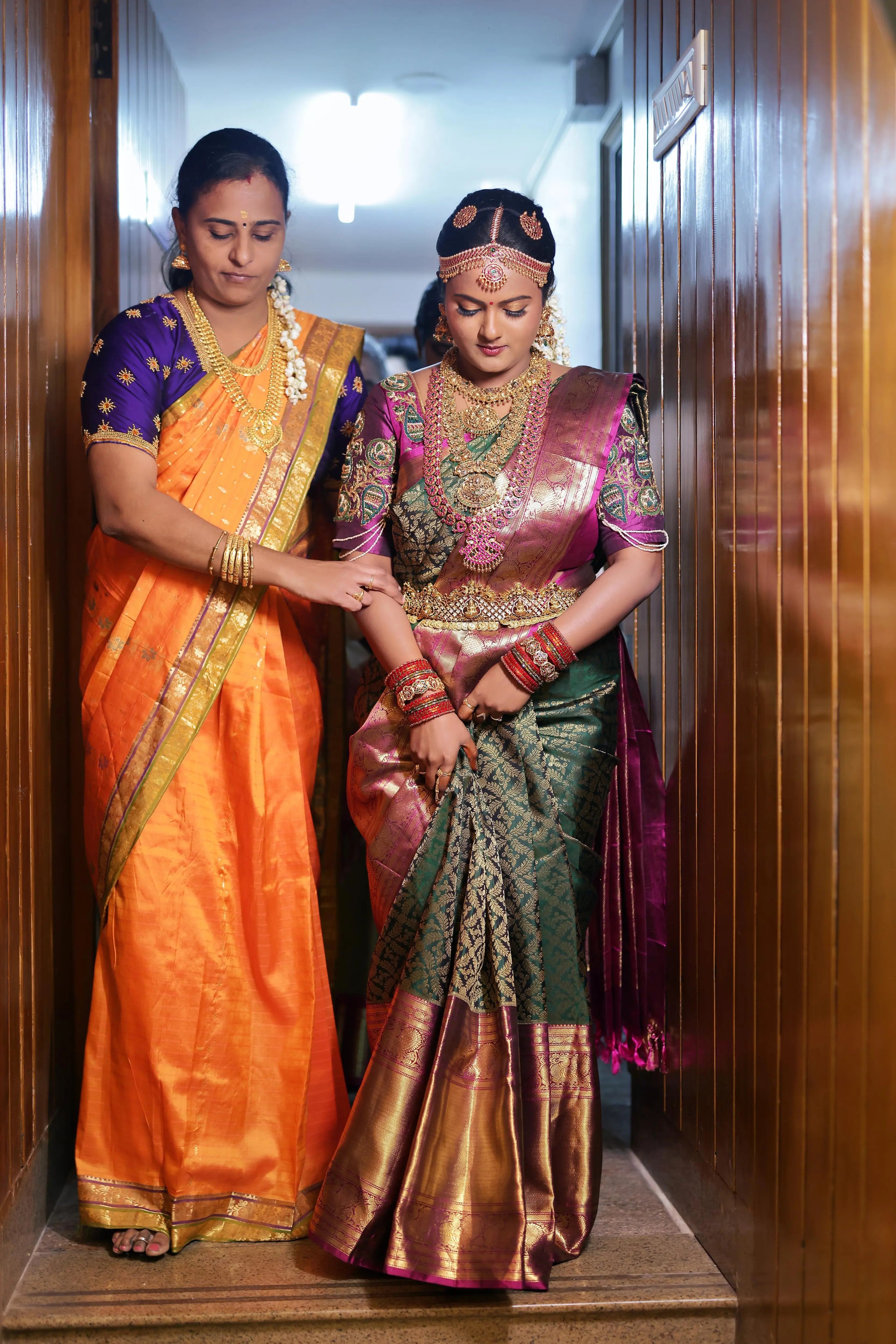 Bride Amirtha posing for photo in a dark magenta silk blouse by team Archana Karthick.