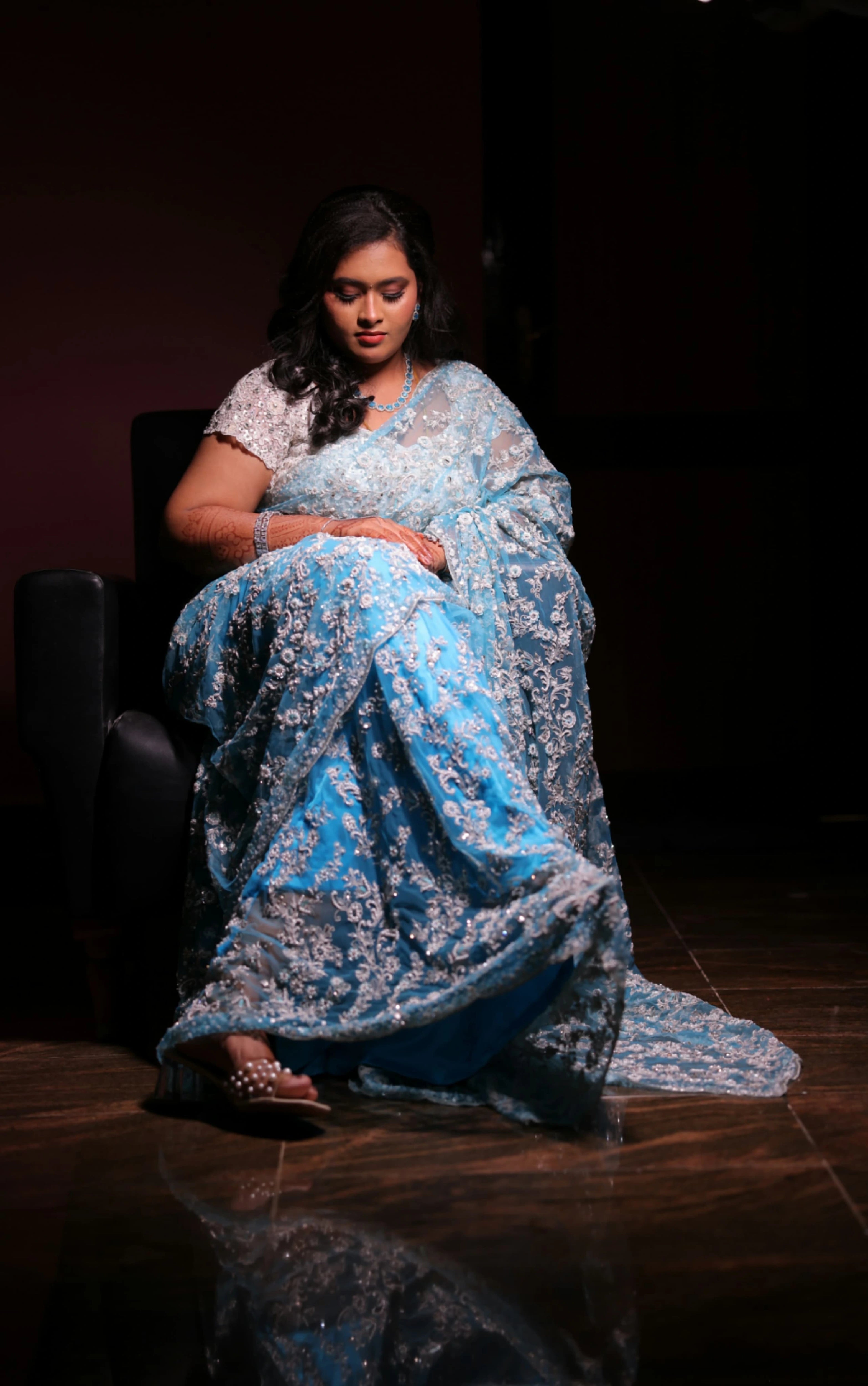 Bride Ananthi Christina posing in a blue tulle saree by team Archana Karthick.