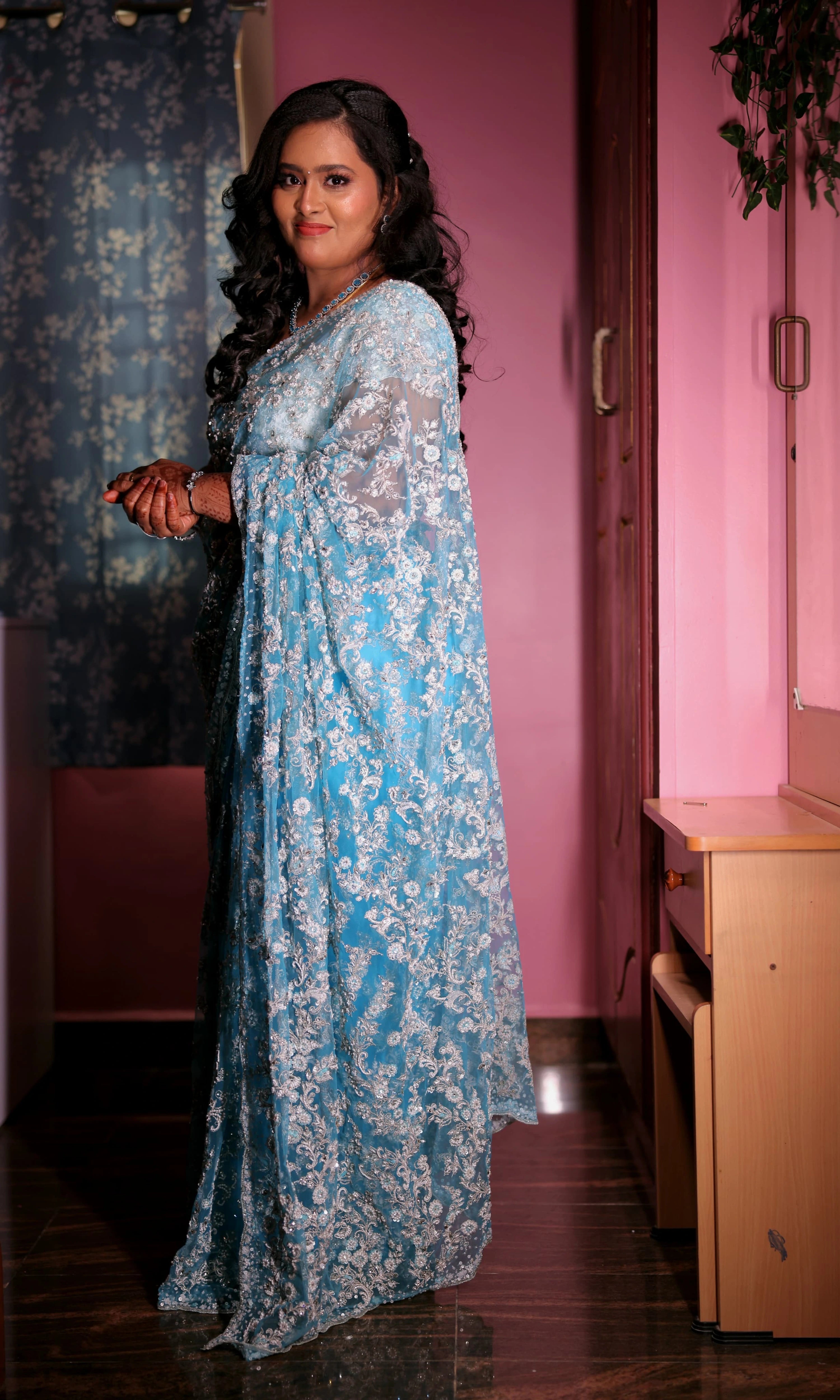 Bride Ananthi Christina smiling in a blue tulle saree by team Archana Karthick.