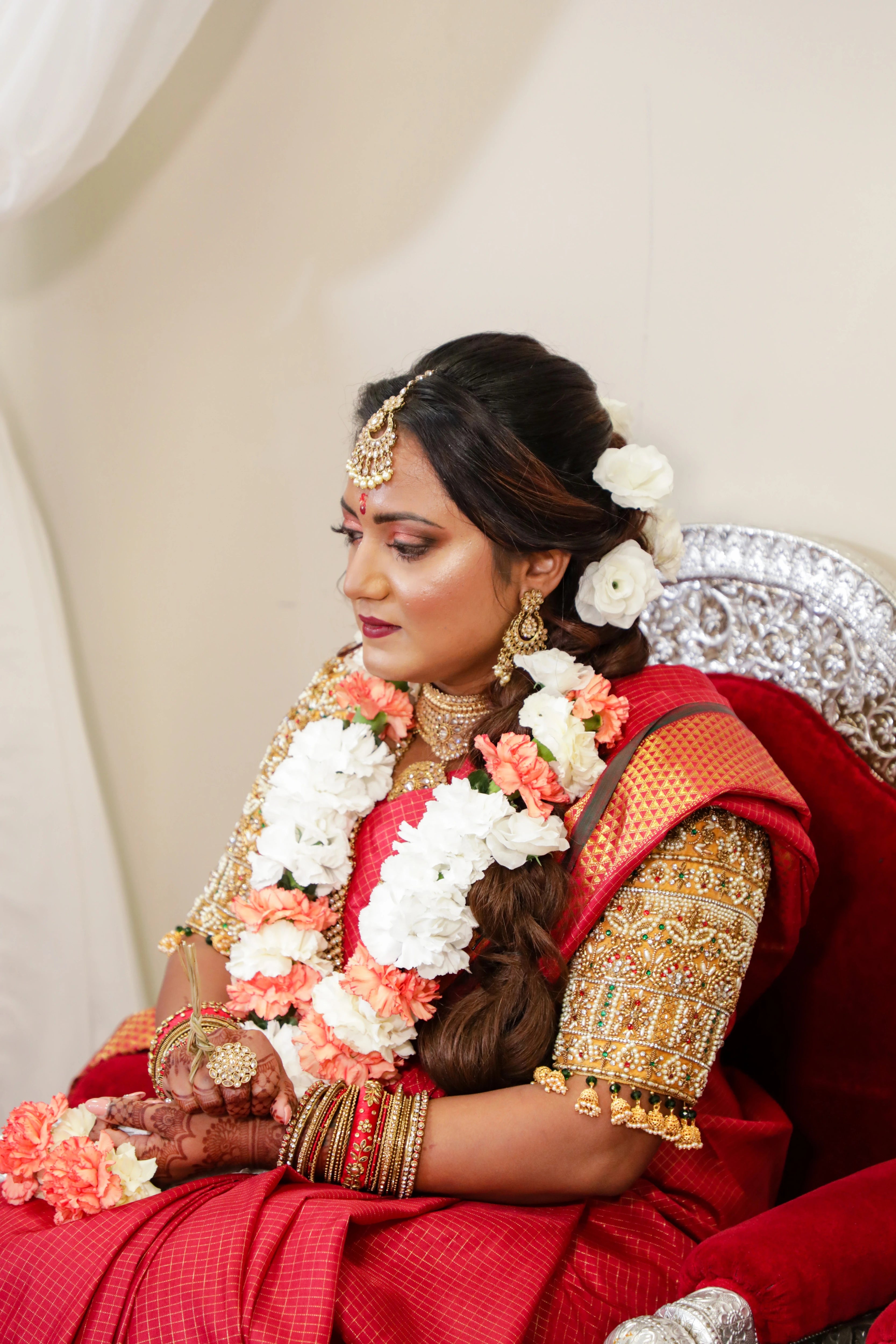 Bride Angeline from Canada posing for photo in a gold silk blouse handcrafted by team Archana Karthick.