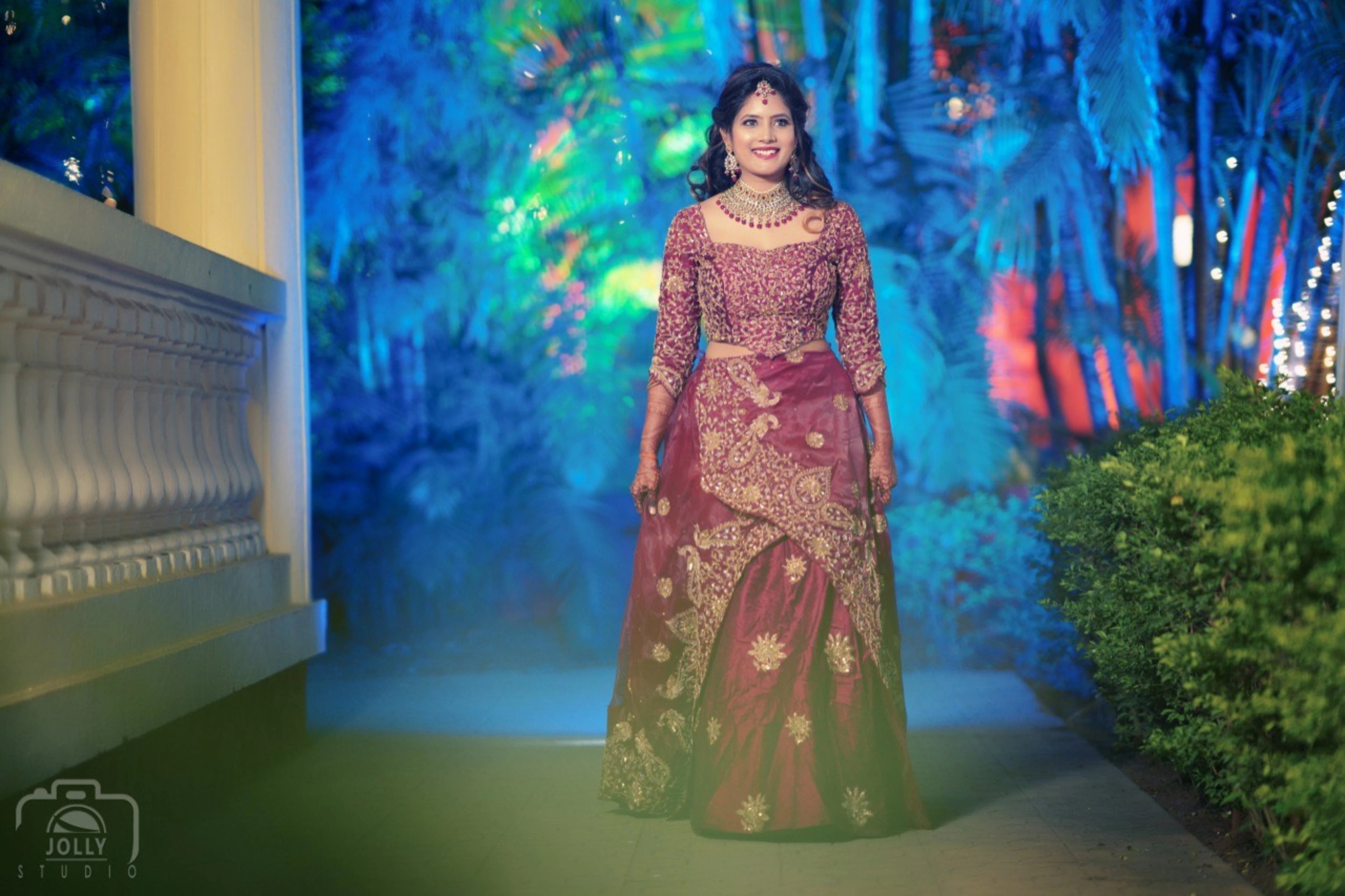 Bride Ankita Singh walking in a red lehenga intricatelty handcrafted with resham, cutdana, zari and beads by team Archana Karthick.