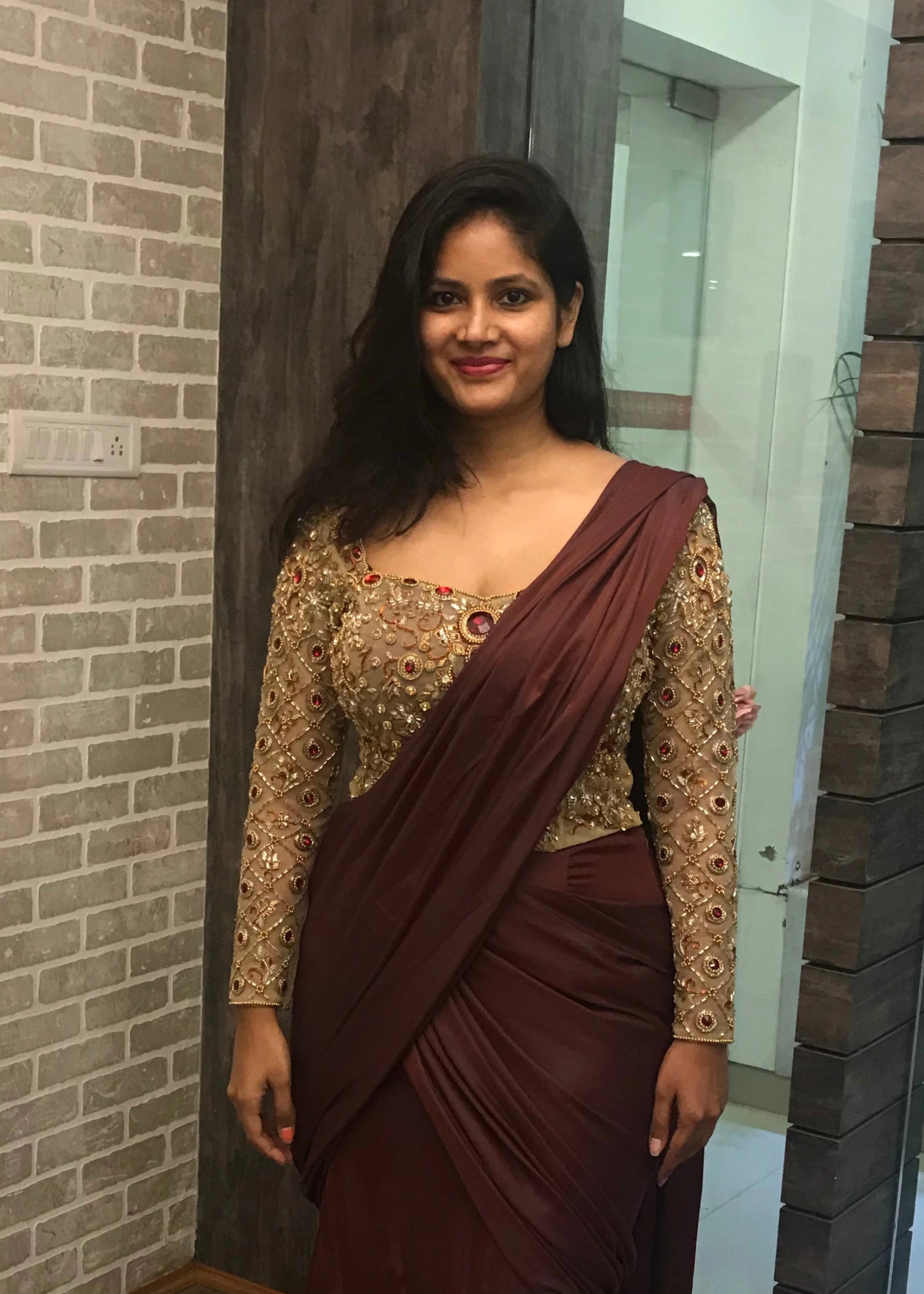 Bride Ankita during fittings in a champagne gold tulle blouse and brown mermaid saree handcrafted by team Archana Karthick.