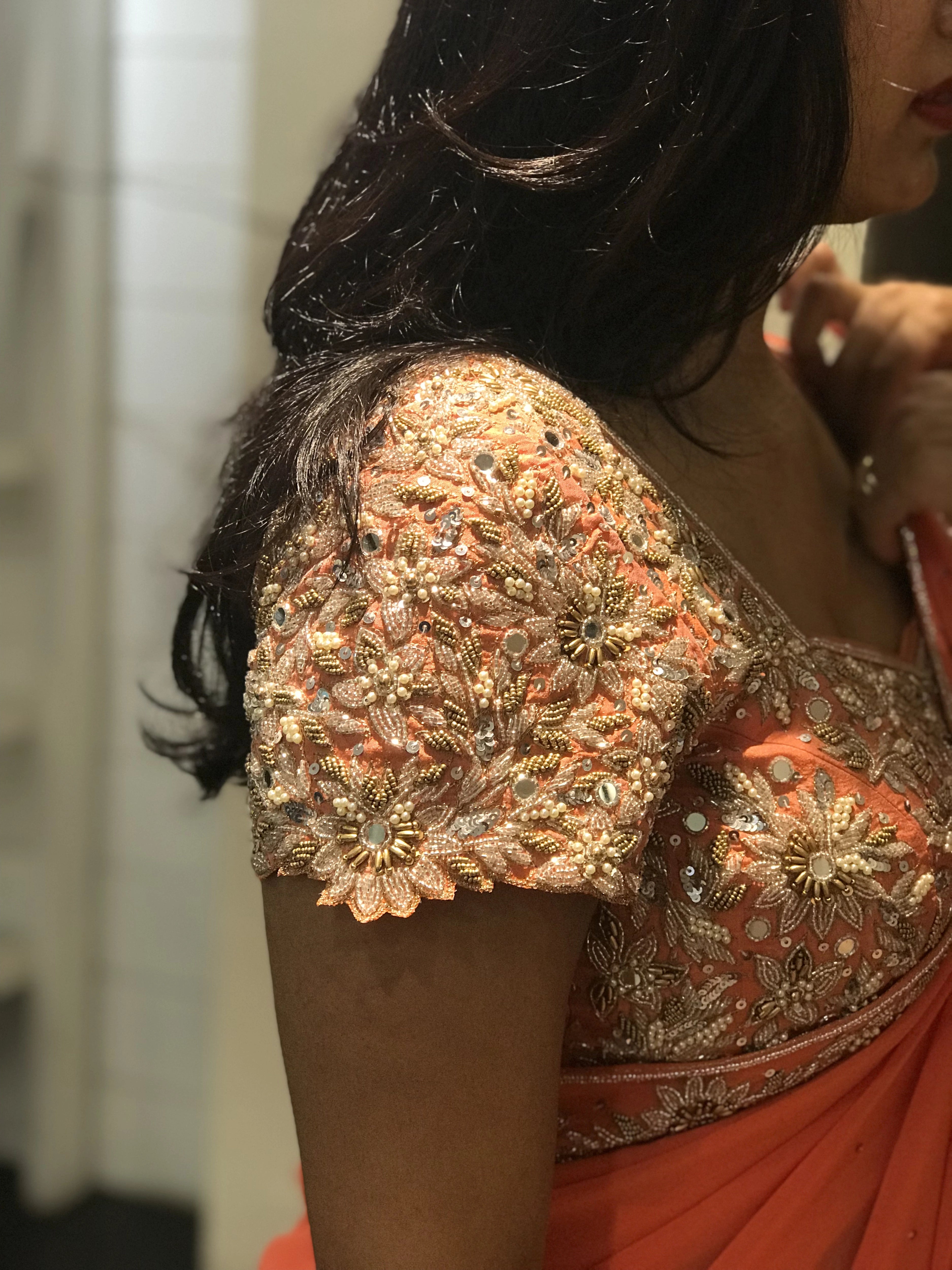 Bride Ankita during fittings in an orange georgette saree and blouse handcrafted by team Archana Karthick.