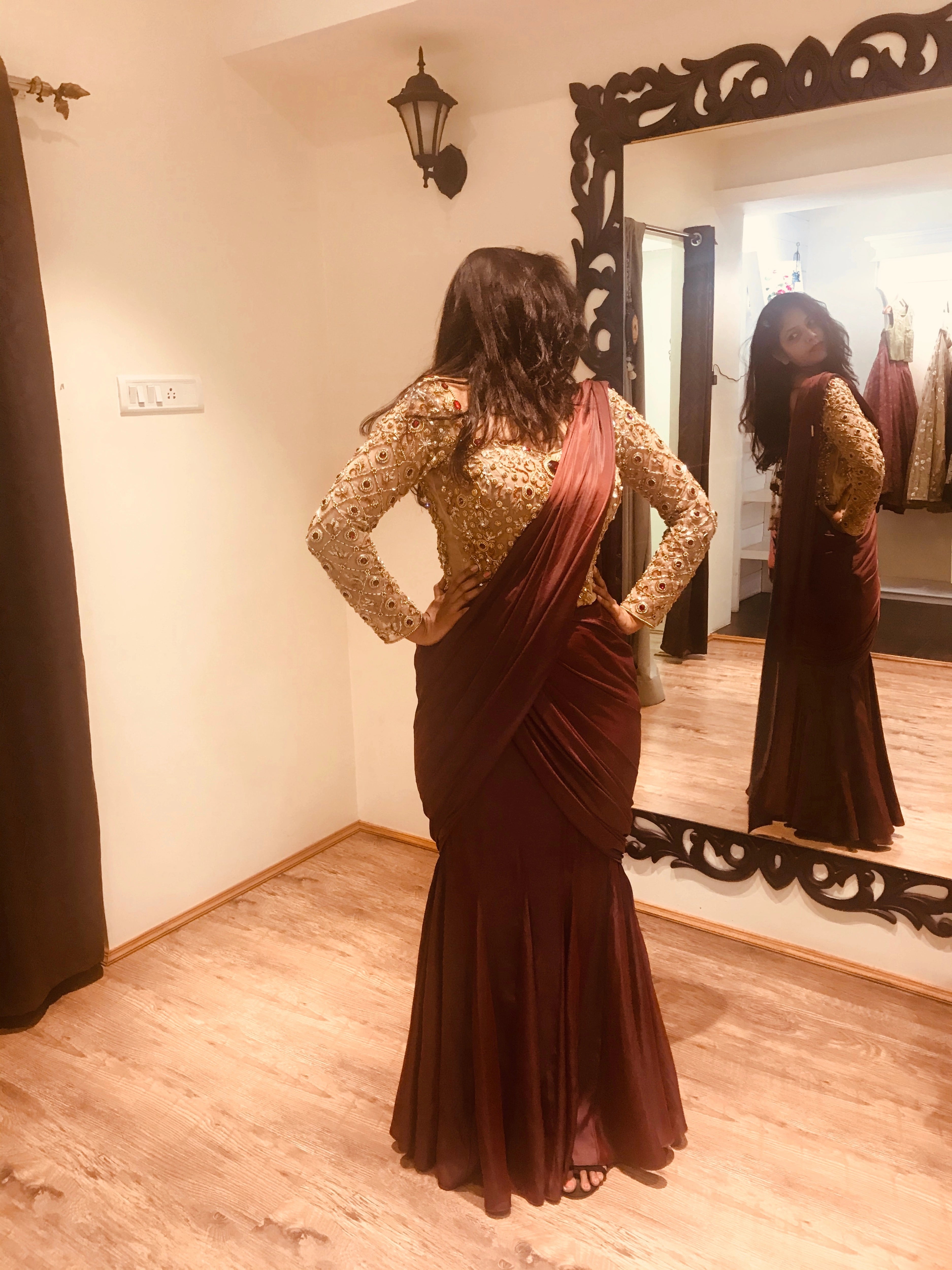 Bride Ankita during her fittings in a champagne gold tulle blouse and brown mermaid saree handcrafted by team Archana Karthick.