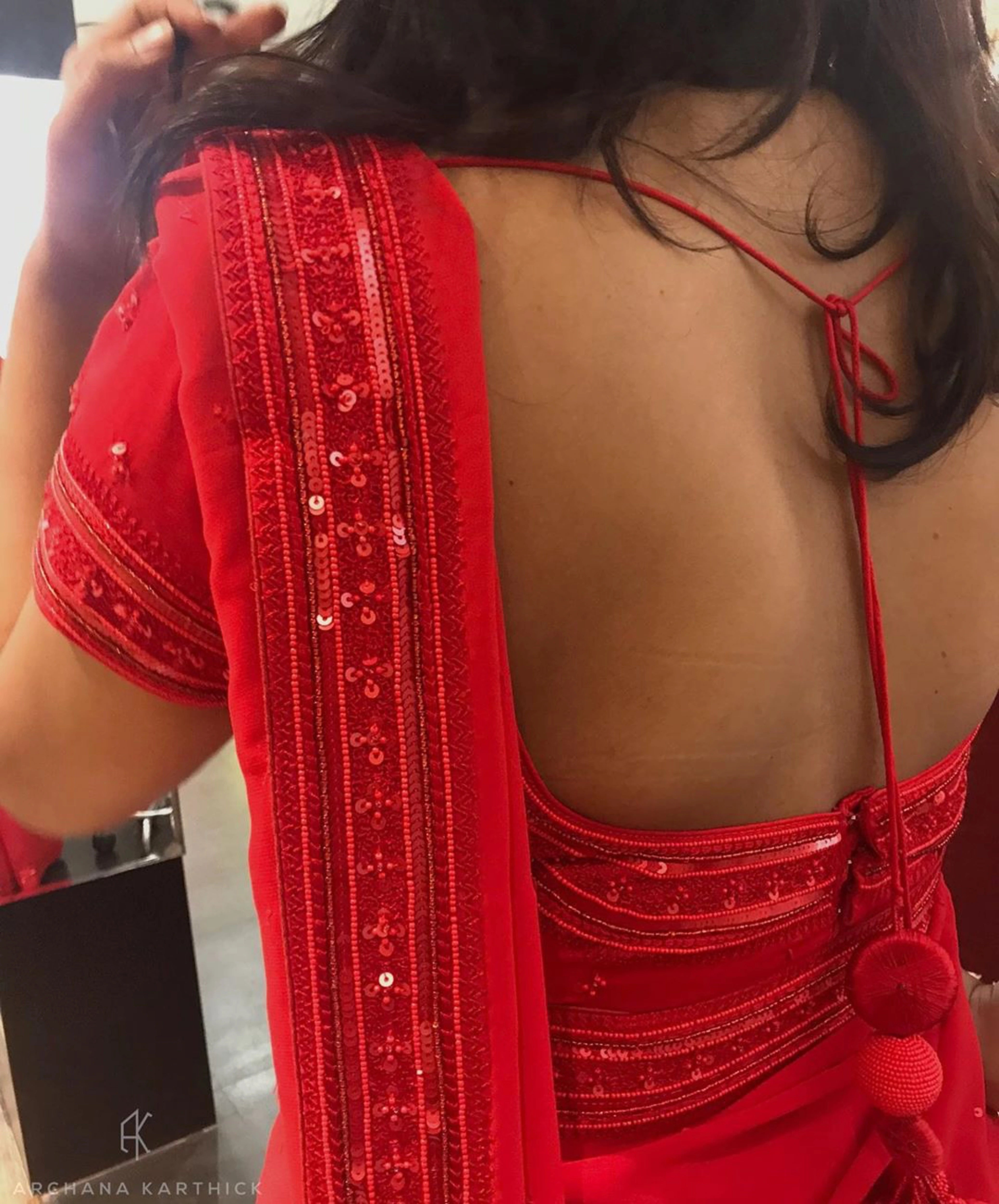 Bride Ankita during her fittings in a red georgette saree and blouse handcrafted by team Archana Karthick.