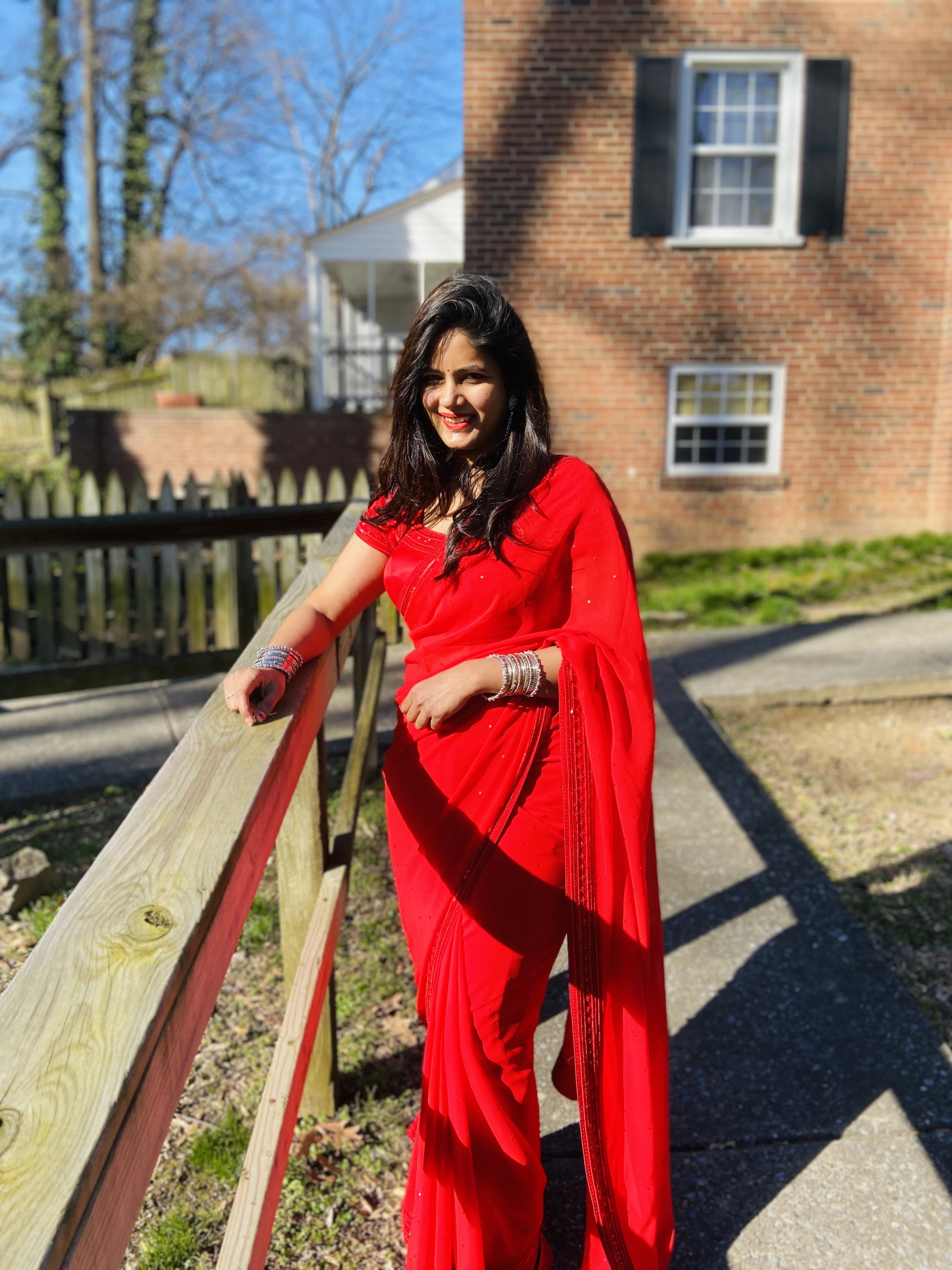 Bride Ankita in a red georgette saree and blouse handcrafted by team Archana Karthick.