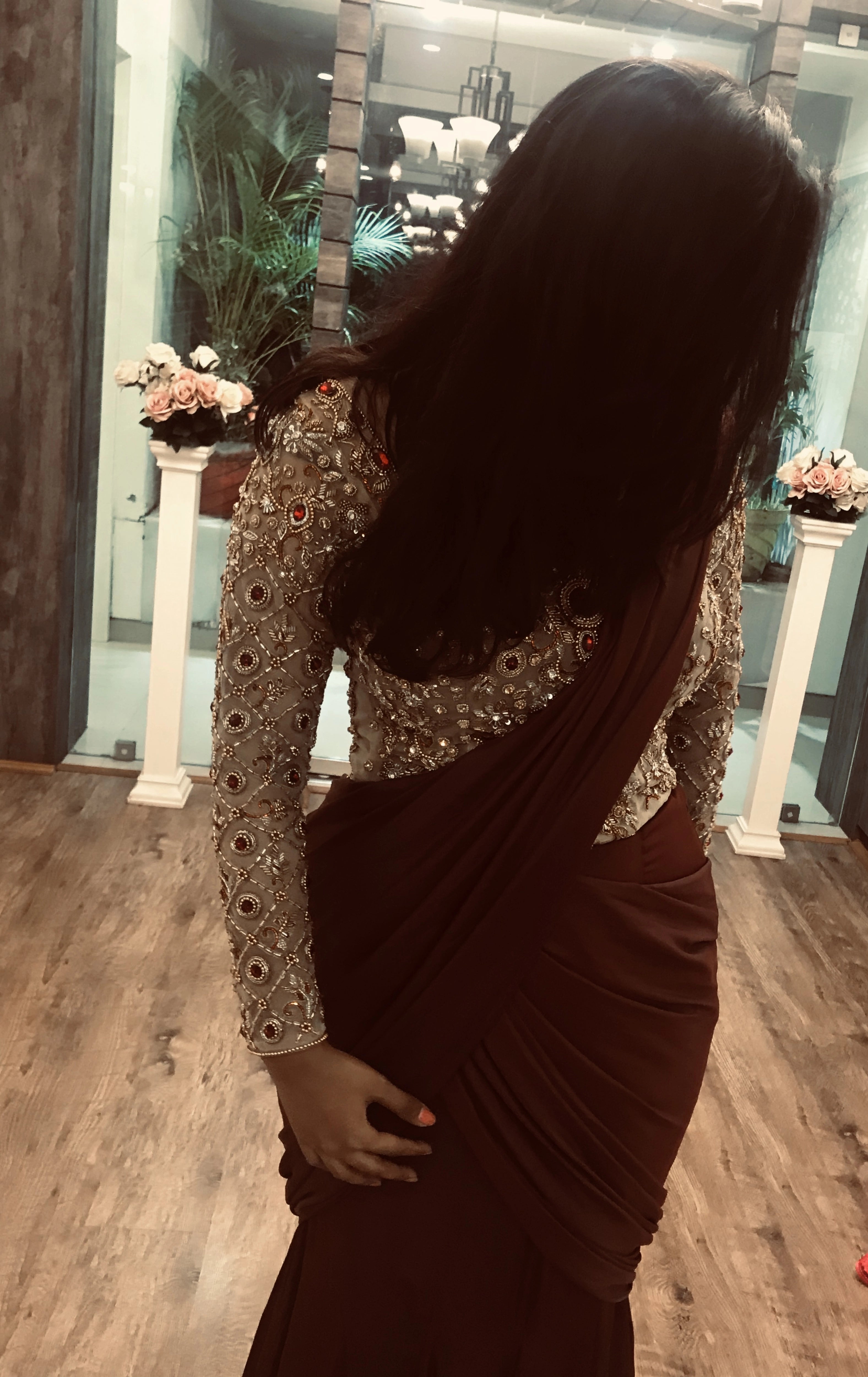 Bride Ankita posing in a champagne gold tulle blouse and brown mermaid saree handcrafted by team Archana Karthick.