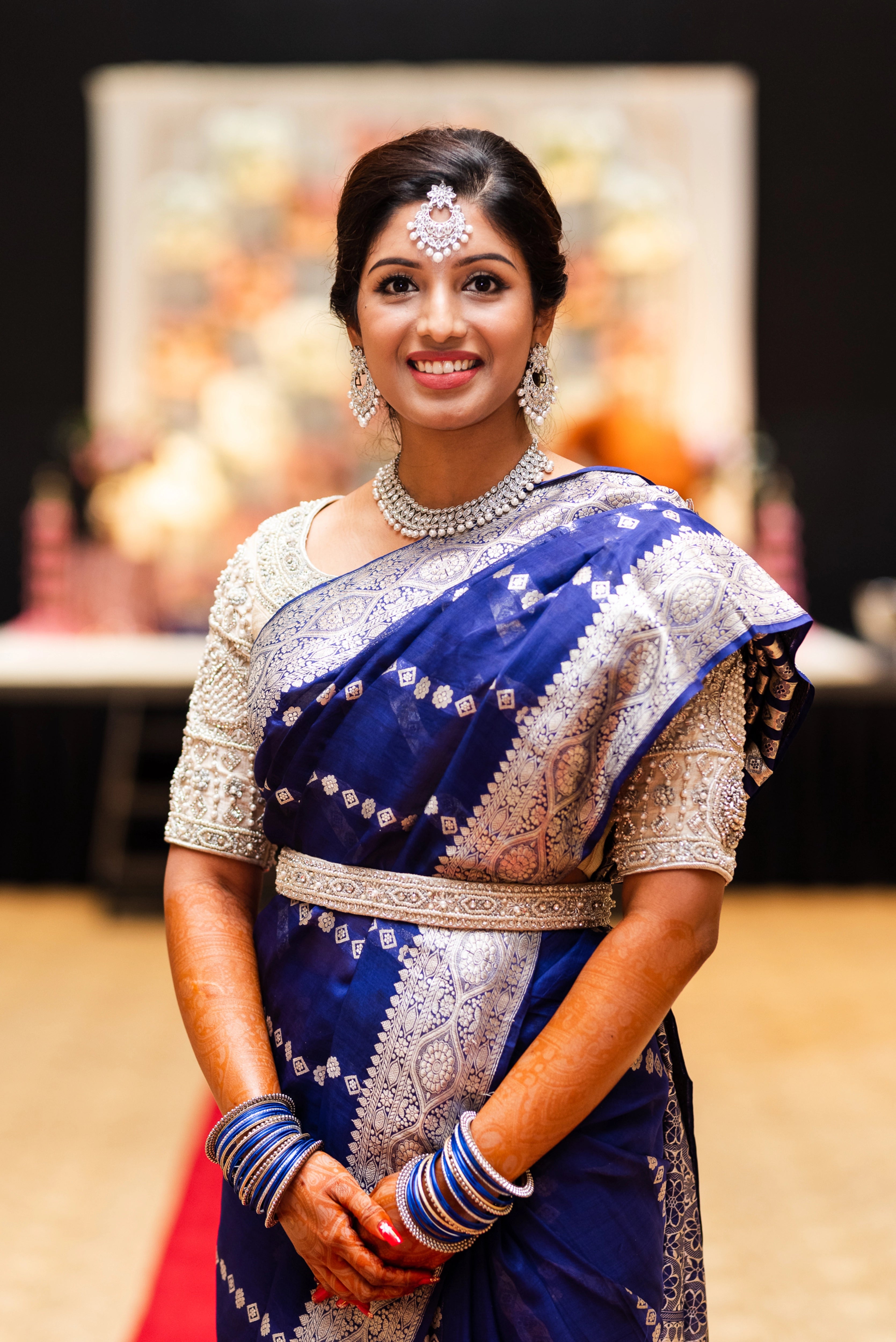 Bride Anusha R from Malaysia in an ivory concept raw silk blouse & belt, intricately handcrafted with zardosi, beads, stones and pearls by team Archana Karthick.