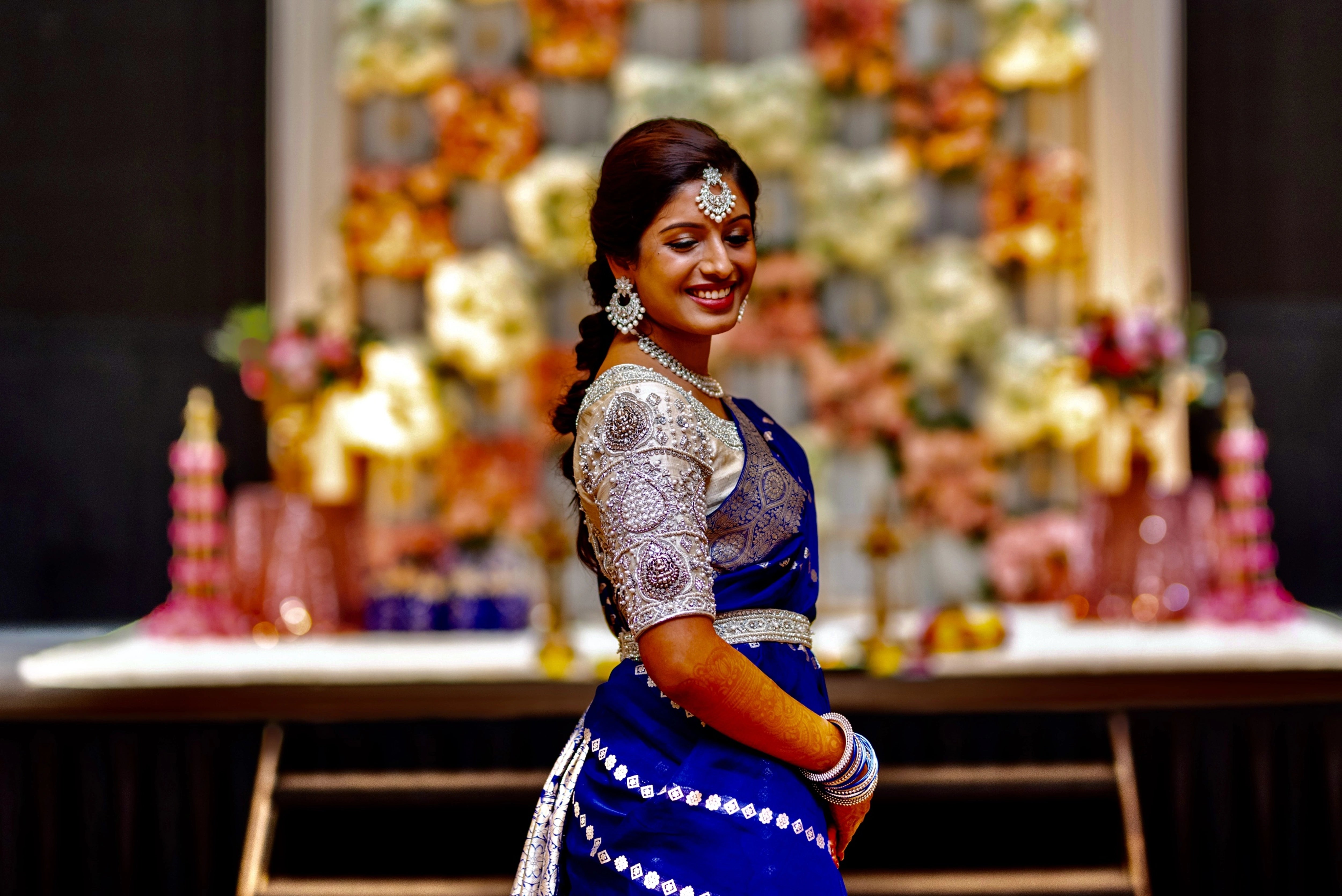 Bride Anusha R from Malaysia showcasing blouse sleeve design in an ivory concept raw silk blouse & belt, intricately handcrafted with zardosi, beads, stones and pearls by team Archana Karthick.