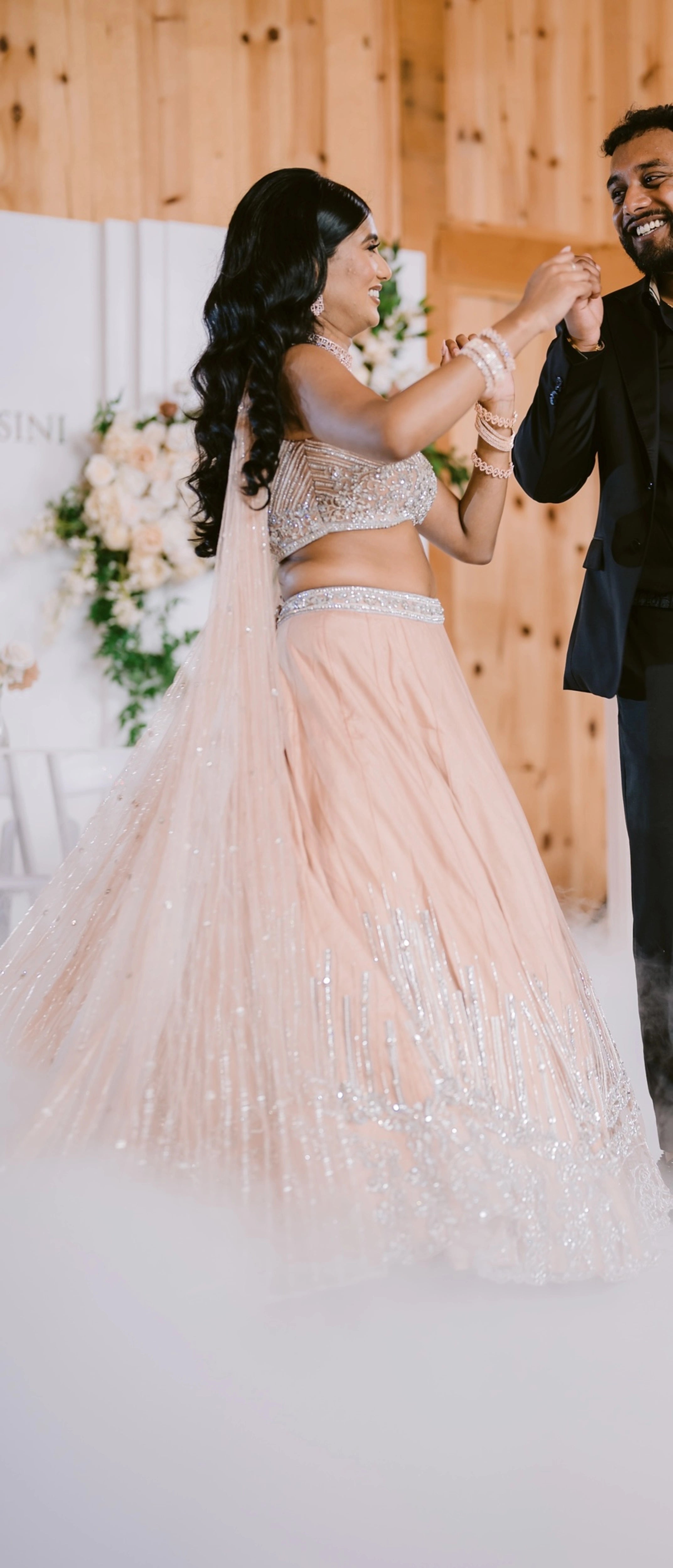 Bride Apy from Canada dancing in a blush (shades of peach cream) lehenga, handcrafted by team Archana Karthick.