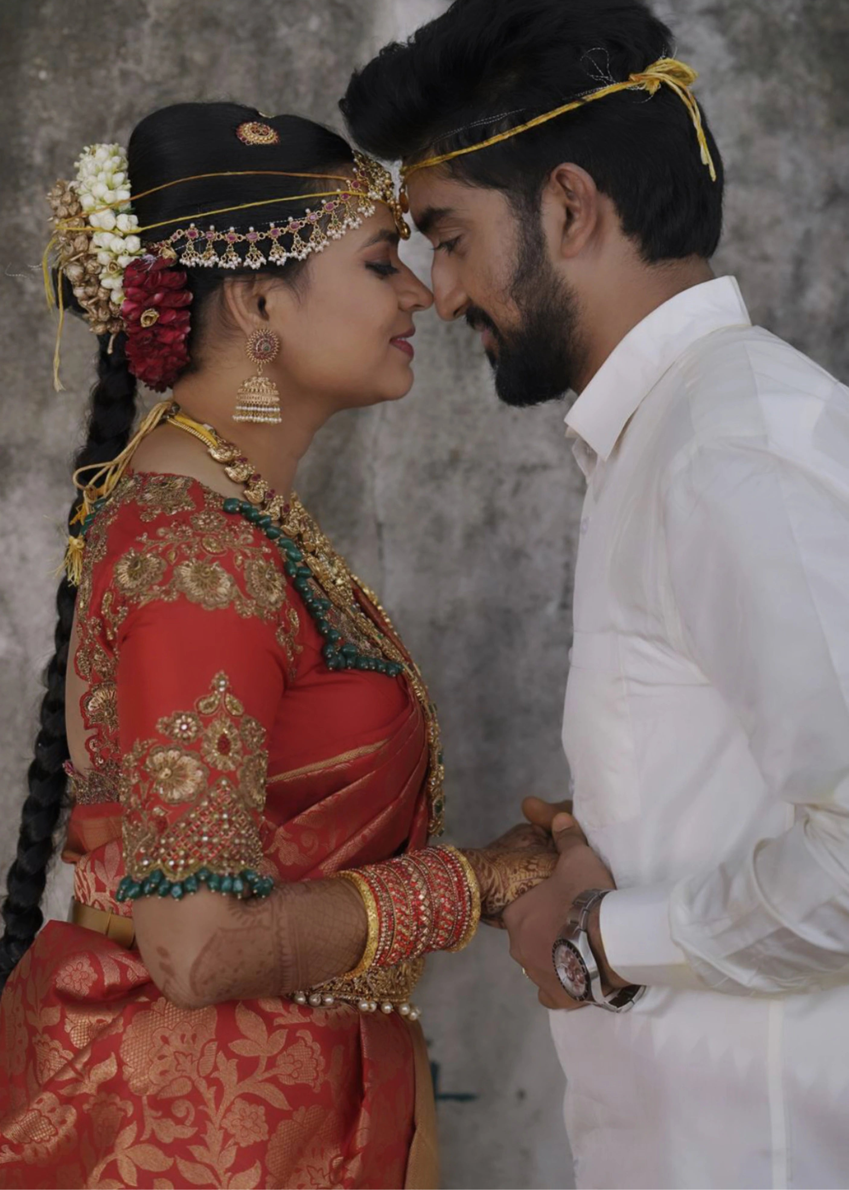 Bride Ashika in a red silk blouse handcrafted by team Archana Karthick