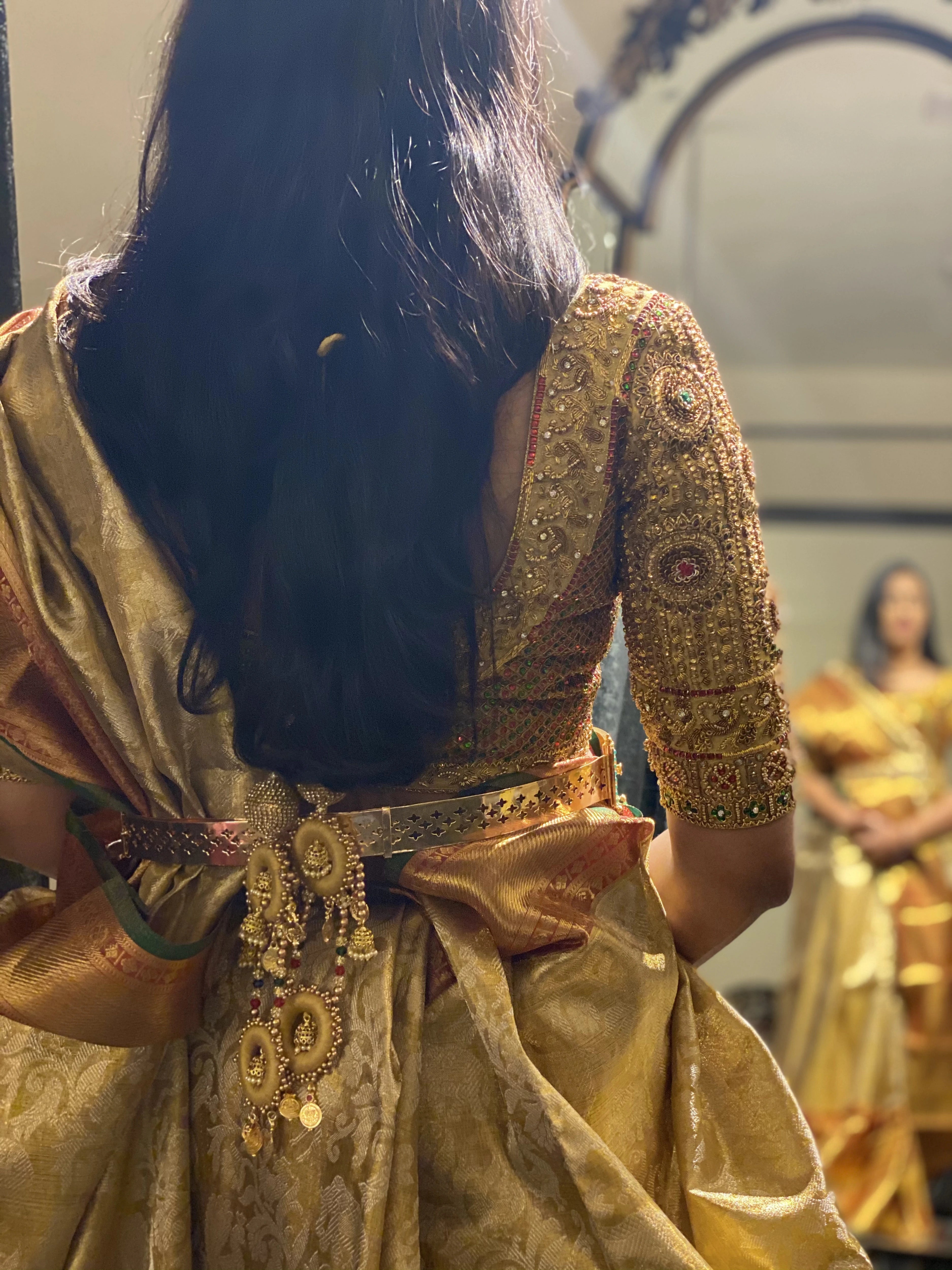 Bride Ashwini during fittings in a gold silk blouse handcrafted by team Archana Karthick.