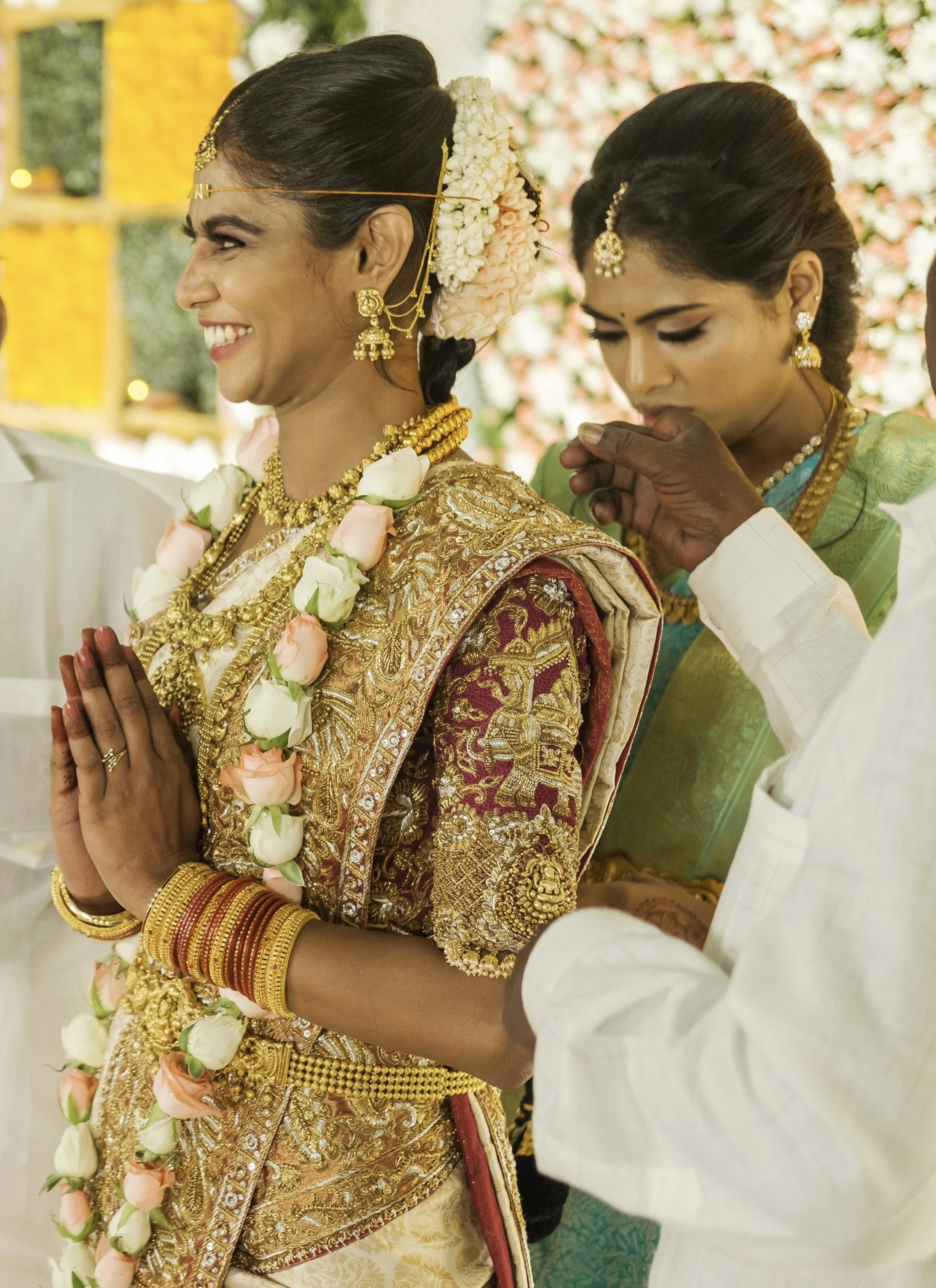 Bride Bhargavi on stagel in a maroon palanquin concept silk blouse and saree border, intricately handcrafted with zardosi, beads, resham work, kundan and sequins by team Archana Karthick.
