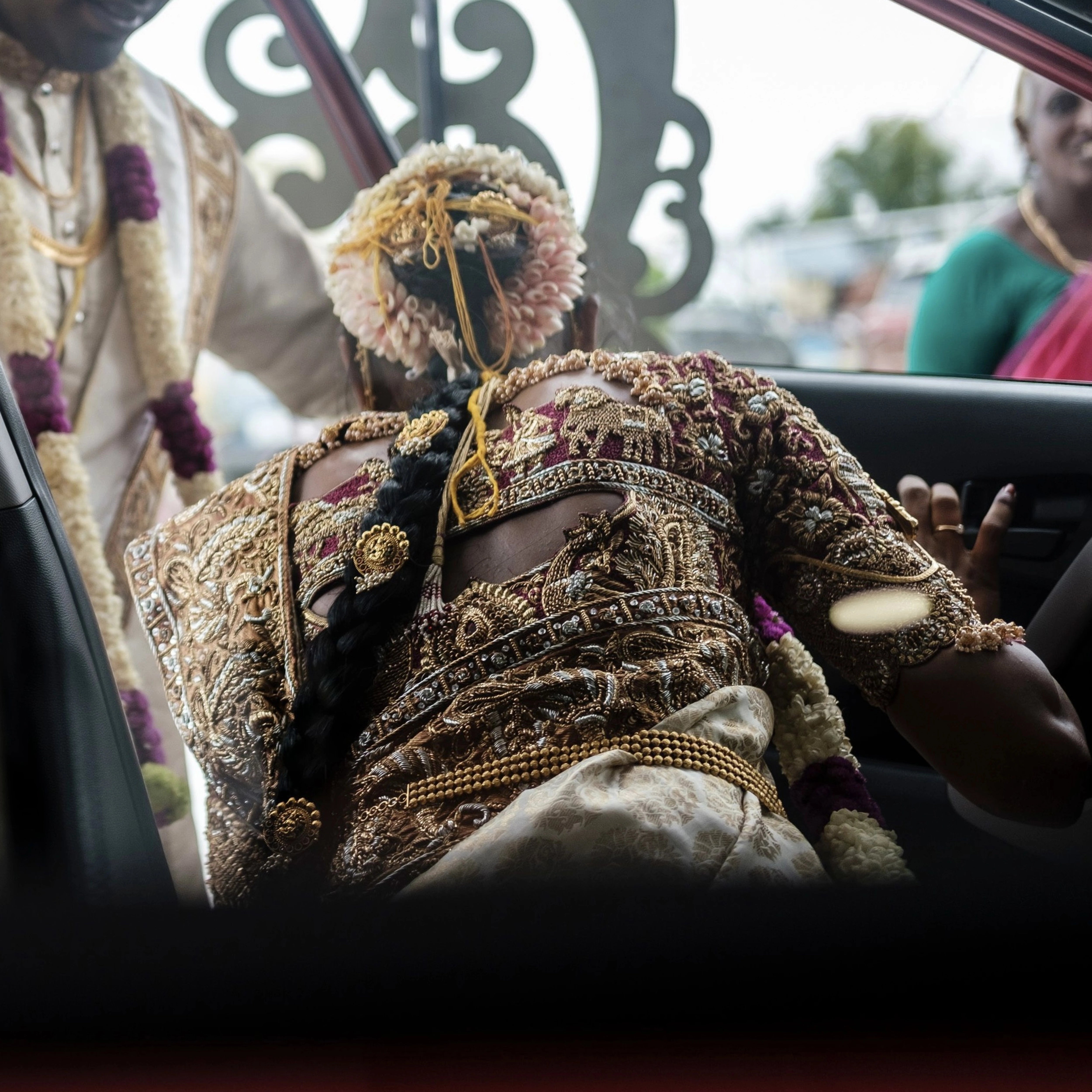 Bride Bhargavi showcasing back blouse design in a maroon palanquin concept silk blouse and saree border, intricately handcrafted with zardosi, beads, resham work, kundan and sequins by team Archana Karthick.