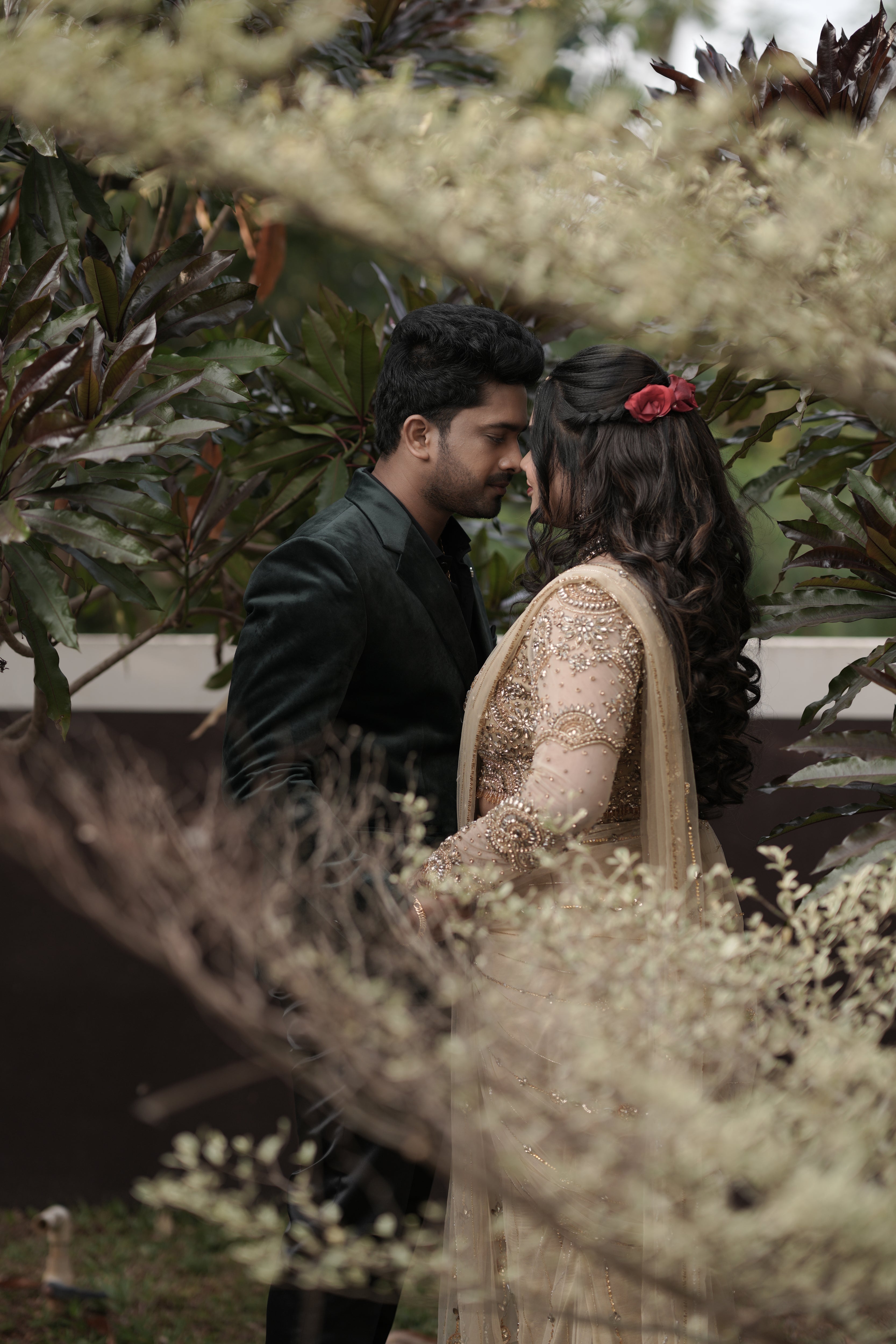 Bride Chithira from Australia, posing in a golden tulle saree by team Archana Karthick.