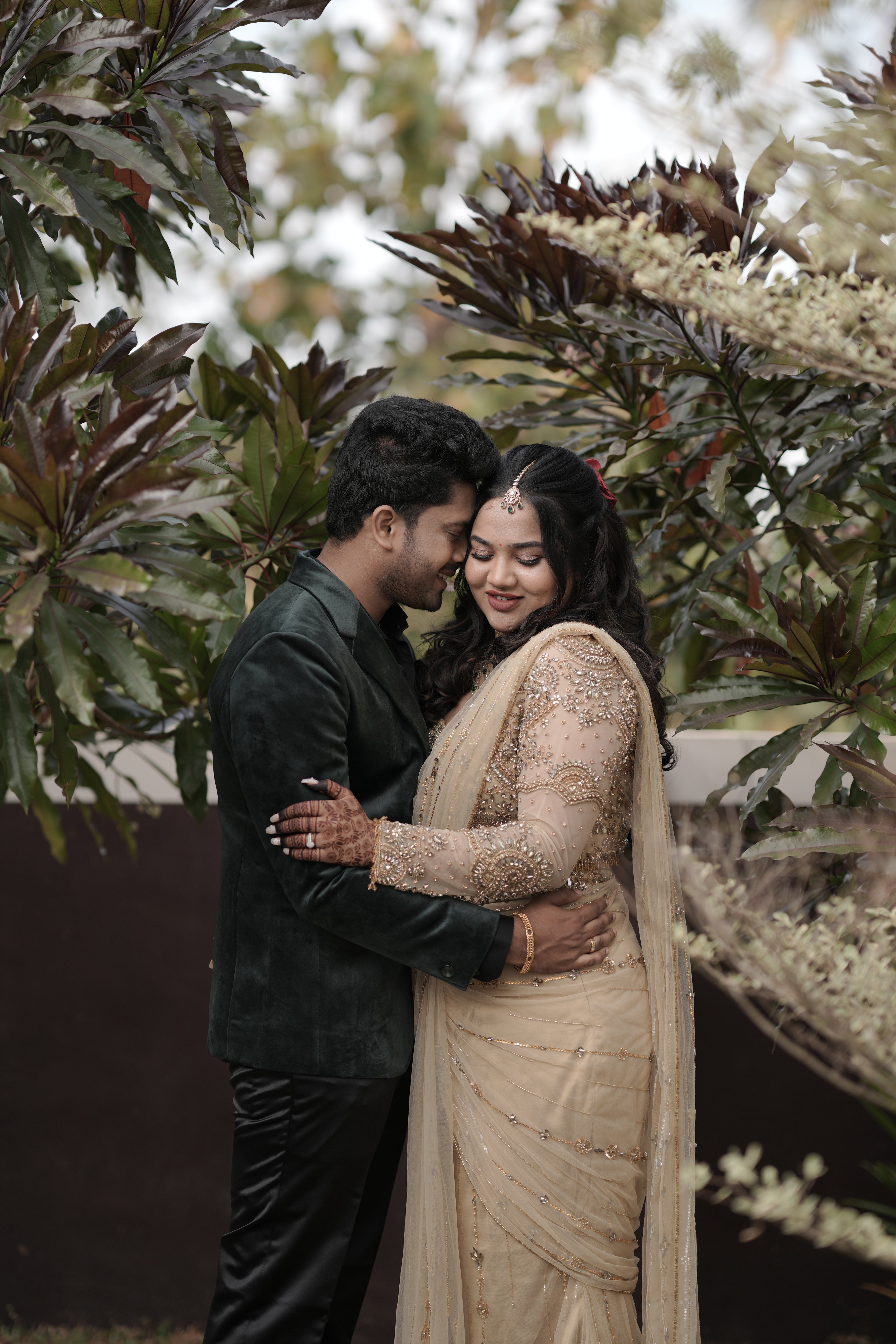 Bride Chithira from Australia, smiling in a golden tulle saree by team Archana Karthick.
