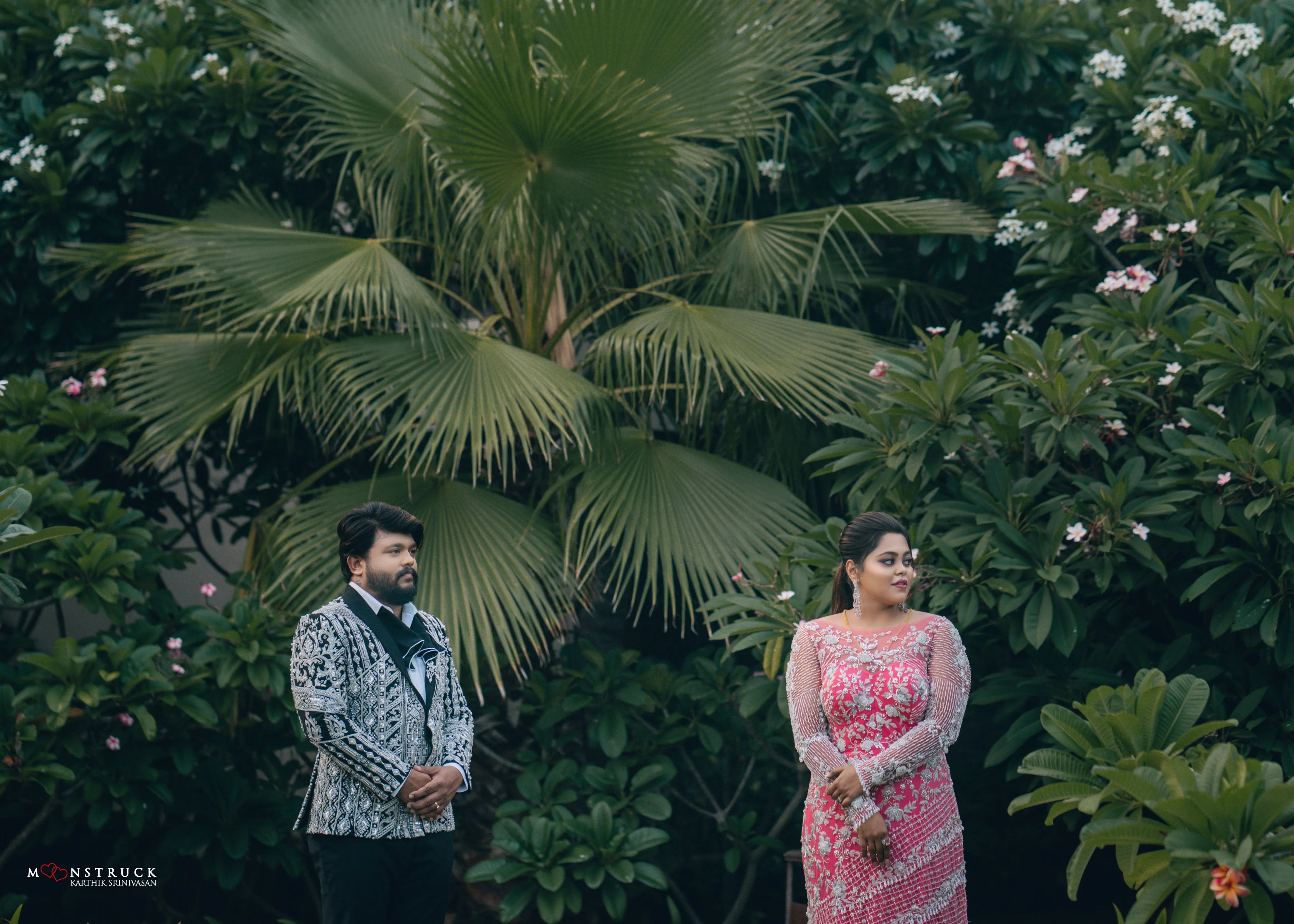 Bride (Coimbatore) in handcrafted pink tulle gown and and Groom (Chennai) in embeliished jacket for their reception front and side profile.