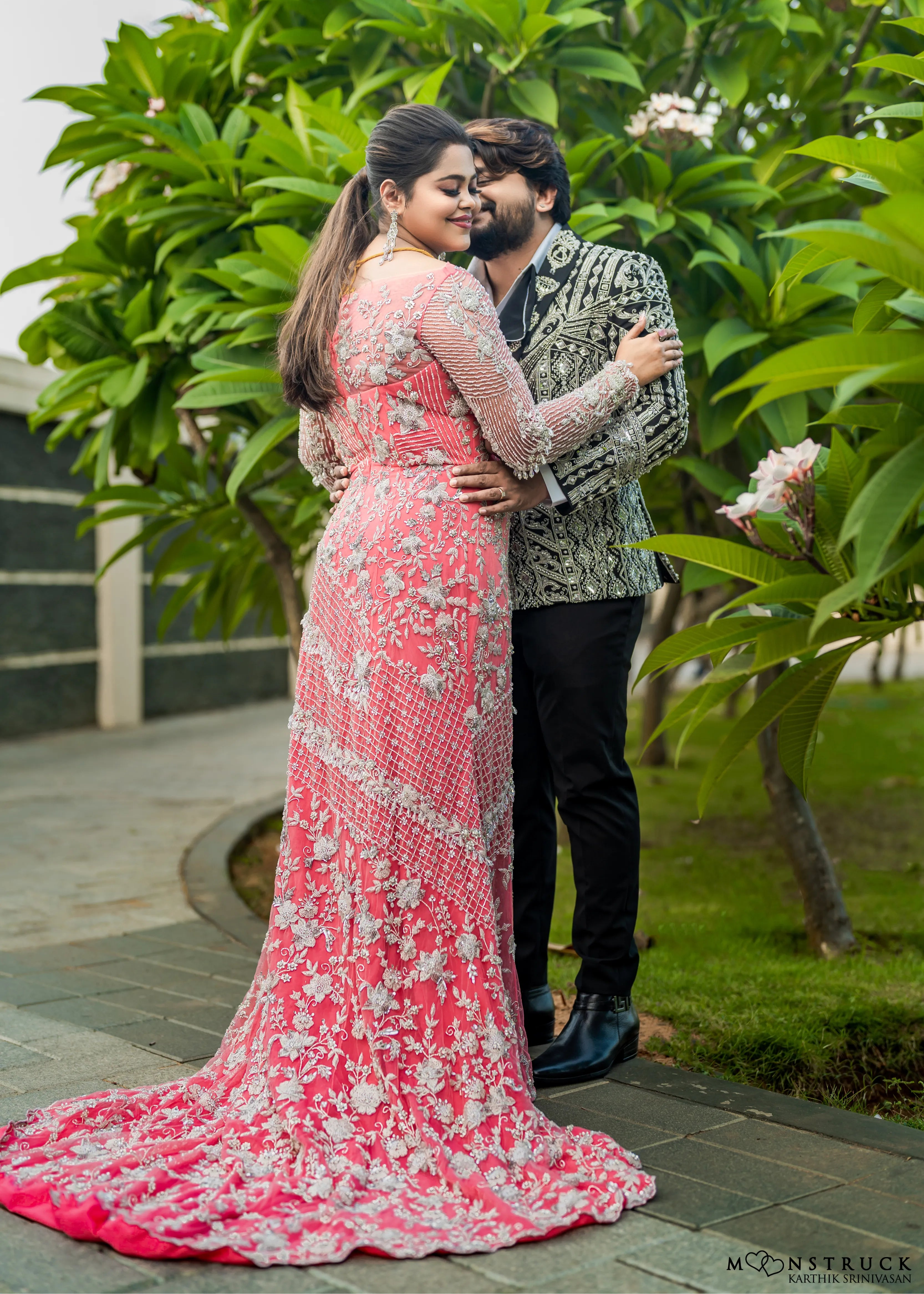 Bride (Coimbatore) in handcrafted pink tulle gown and and Groom (Chennai) in embeliished jacket for their reception in an embrace.
