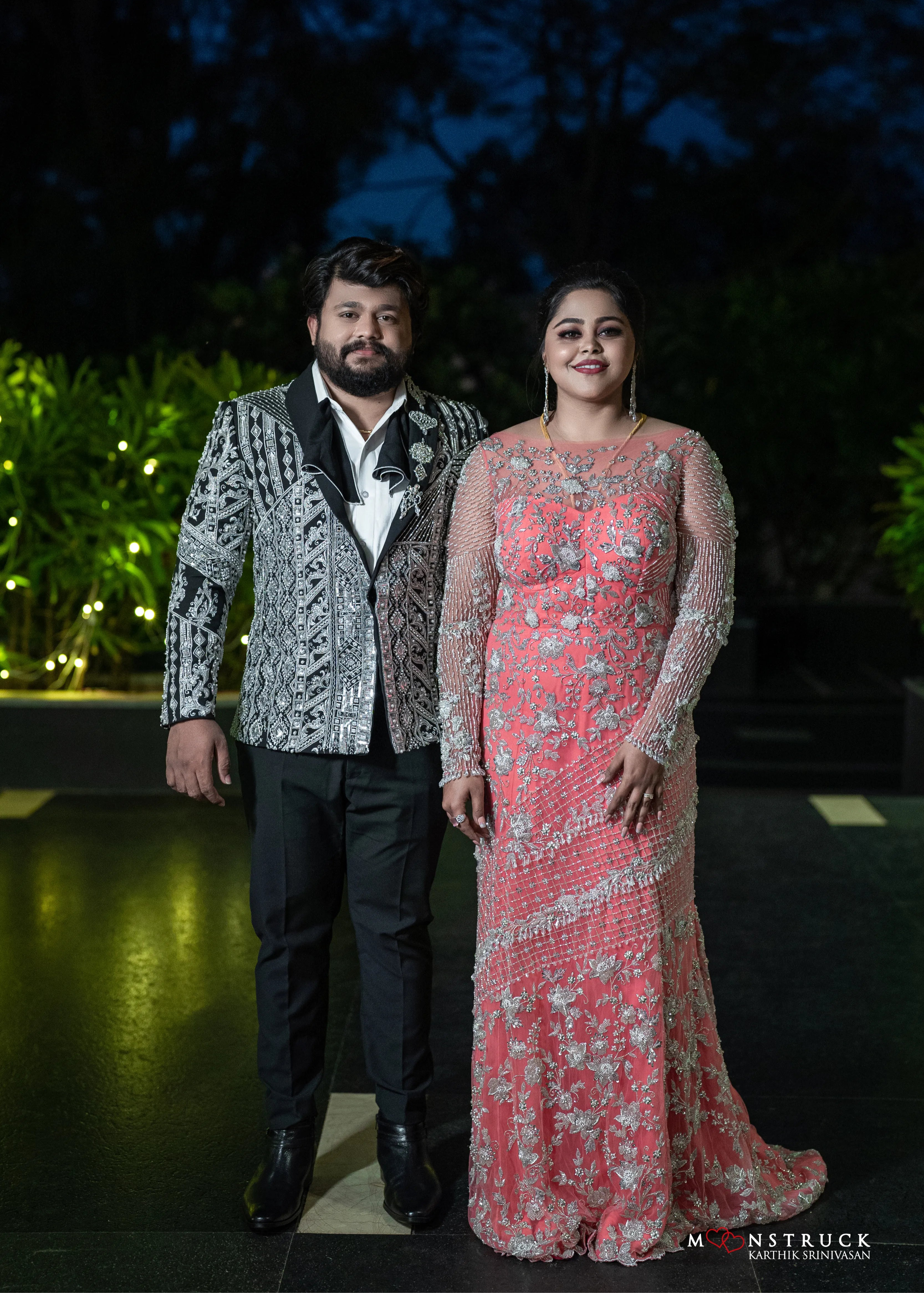 Bride (Coimbatore) in handcrafted pink tulle gown and and Groom (Chennai) in embeliished jacket for their reception posing straight.