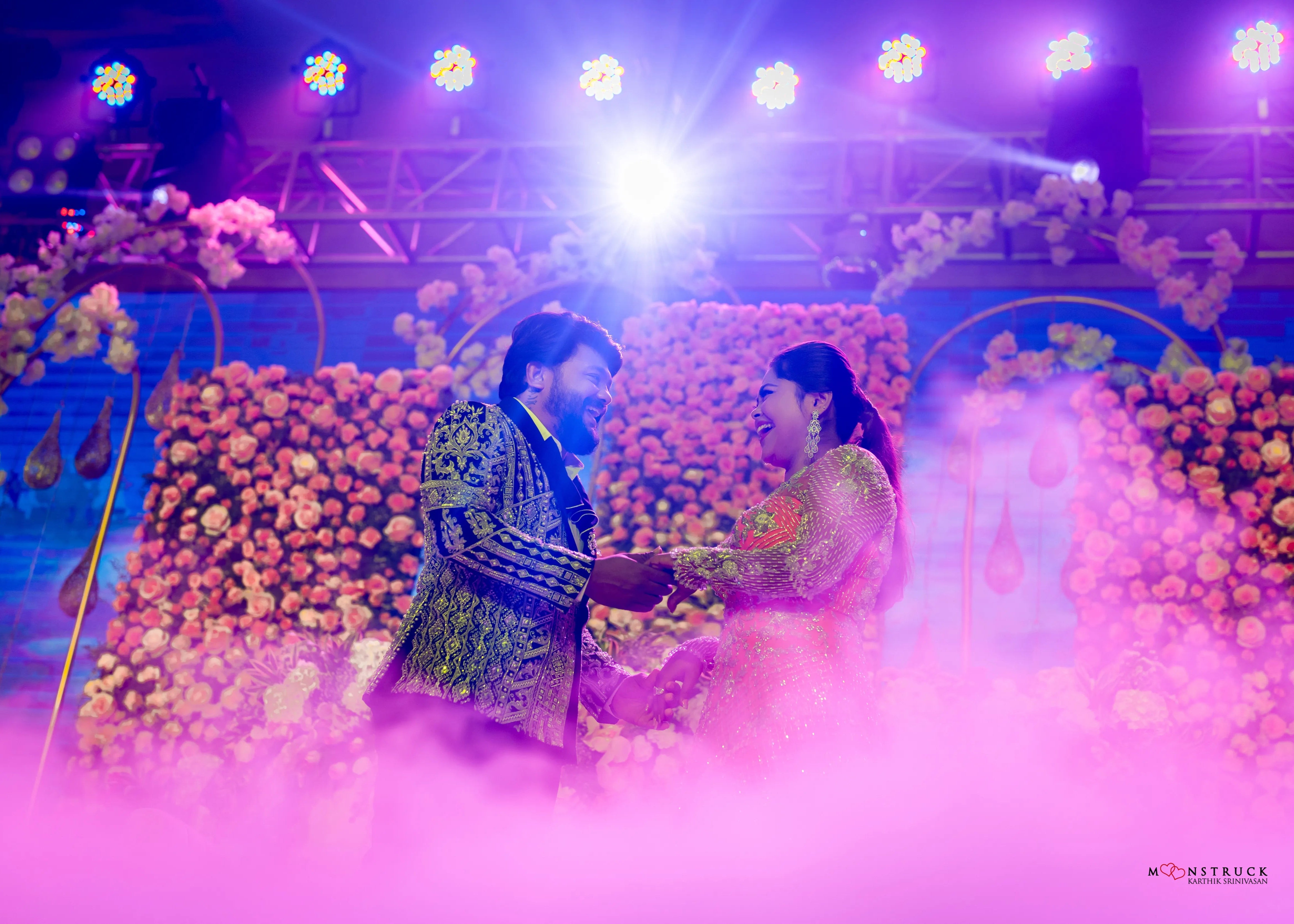 Bride (Coimbatore) in handcrafted pink tulle gown and and Groom (Chennai) in embeliished jacket for their reception side profile.
