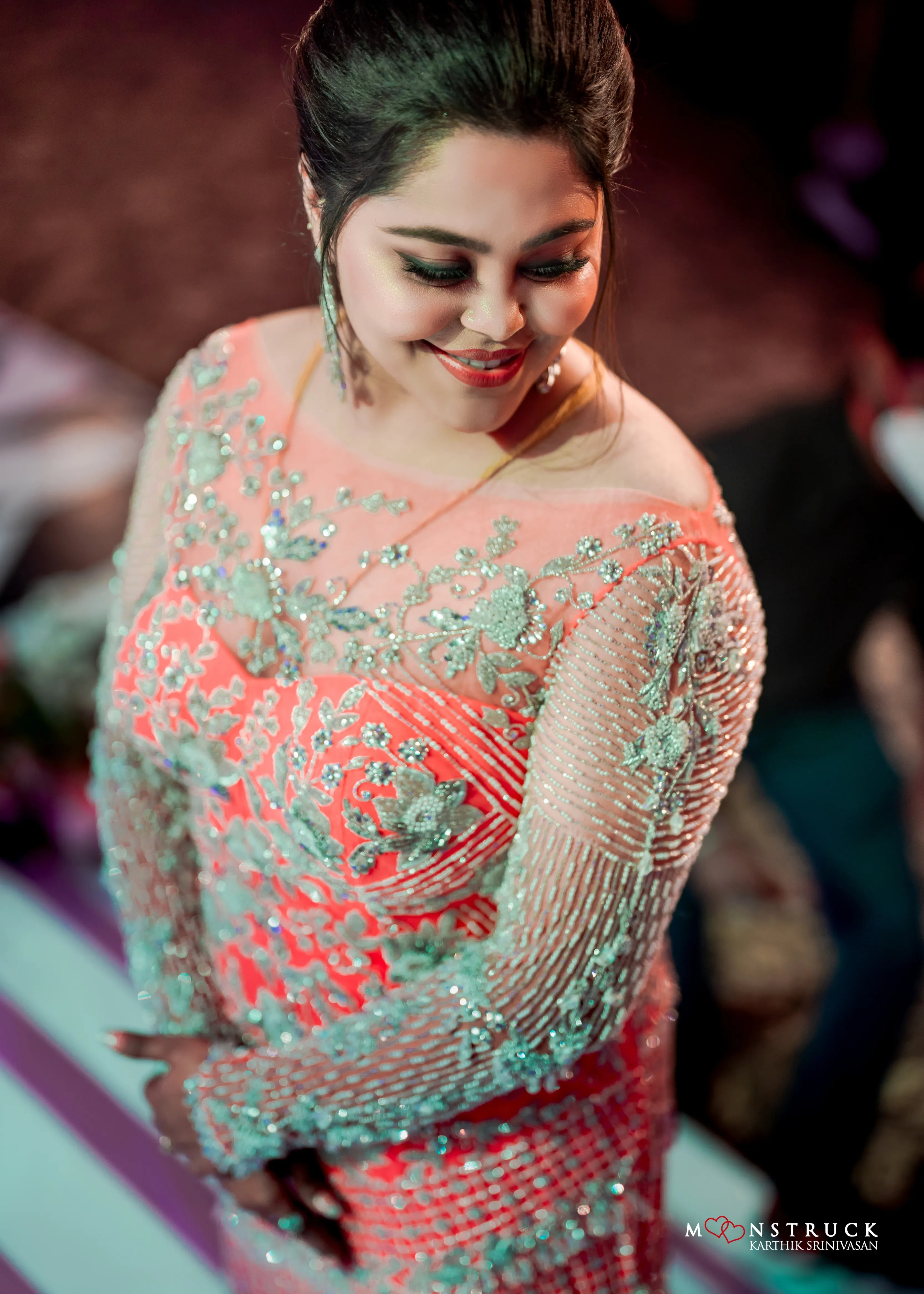Bride (Coimbatore) in handcrafted pink tulle gown for her reception photoshoot on stage.