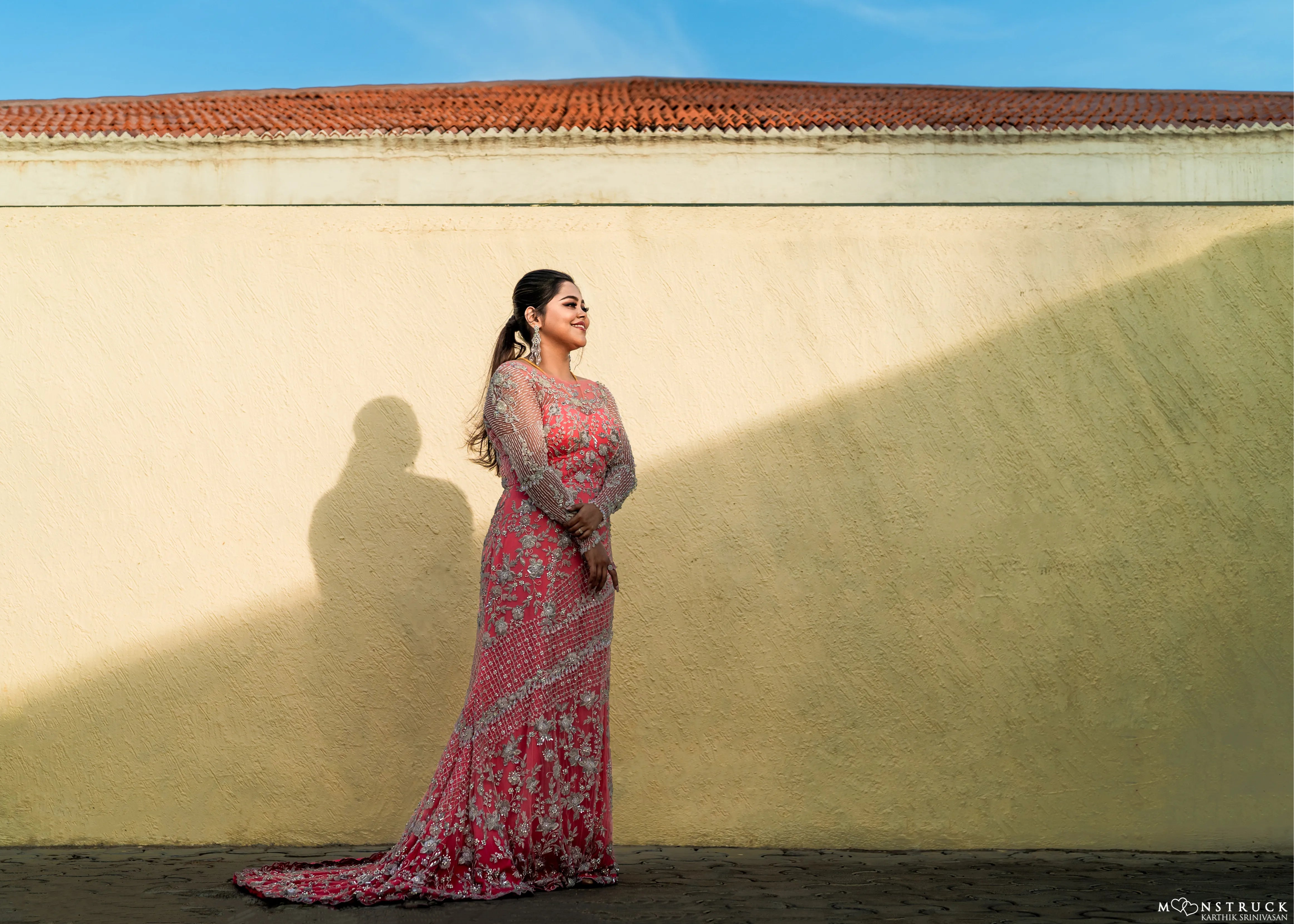 Bride (Coimbatore) in handcrafted pink tulle gown for their reception photoshoot on stage.