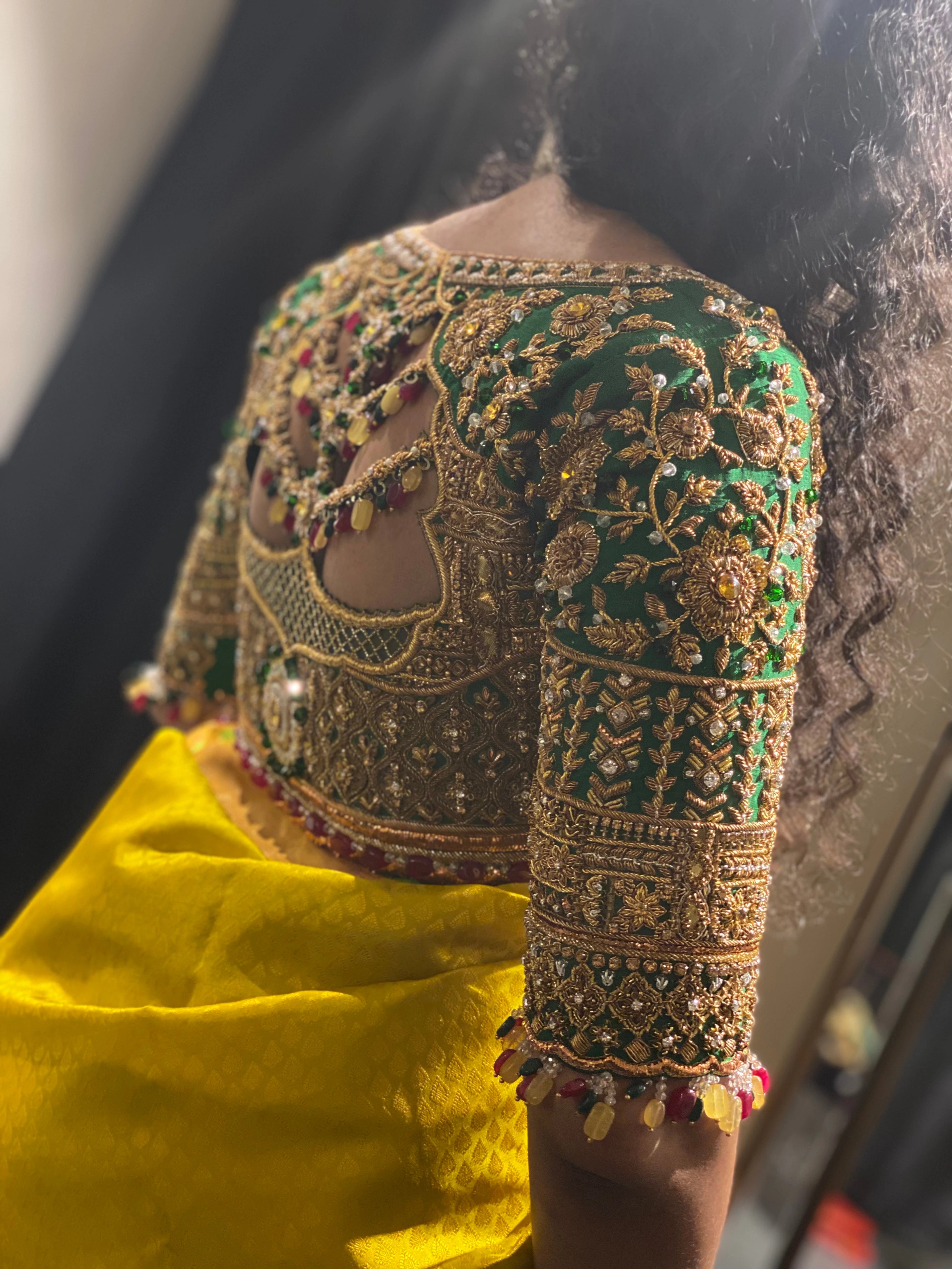 Bride Cris during her fittings in a bottle green silk blouse handcrafted by team Archana Karthick.